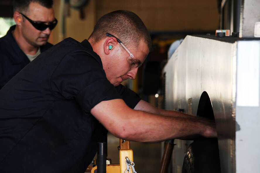 BARKSDALE AIR FORCE BASE, La. -- Senior Airman Christopher Taylor, 2nd Logistics Readiness Squadron vehicle maintenance mechanic removes a tire from a vehicle Sept. 14. The LRS has approximately 820 vehicles supporting Barksdale?s mission. (U.S. Air Force photo/Senior Airman Brittany Y. Bateman)(RELEASED)