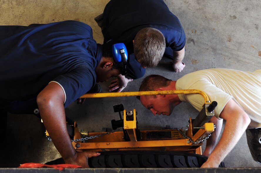 BARKSDALE AIR FORCE BASE, La. -- Vehicle maintenance mechanics with the 2nd Logistics Readiness Squadron, put a wheel back on a vehicle Sept. 14. The LRS provides a variety of support across the base. Vehicle support consists of aircrew buses and a U-Drive-It fleet, as well as the maintenance of a $46 million vehicle fleet. (U.S. Air Force photo/Senior Airman Brittany Y. Bateman)(RELEASED)