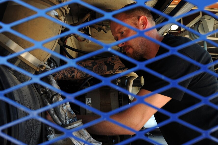 BARKSDALE AIR FORCE BASE, La. -- Chris Rowell, 2nd Logistics Readiness Squadron vehicle maintenance mechanic repairs, a vehicle air conditioning unit Sept. 14. The LRS provides a variety of support across the base. Vehicle support consists of aircrew buses and a U-Drive-It fleet, as well as the maintenance of a $46 million vehicle fleet. (U.S. Air Force photo/Senior Airman Brittany Y. Bateman)(RELEASED)