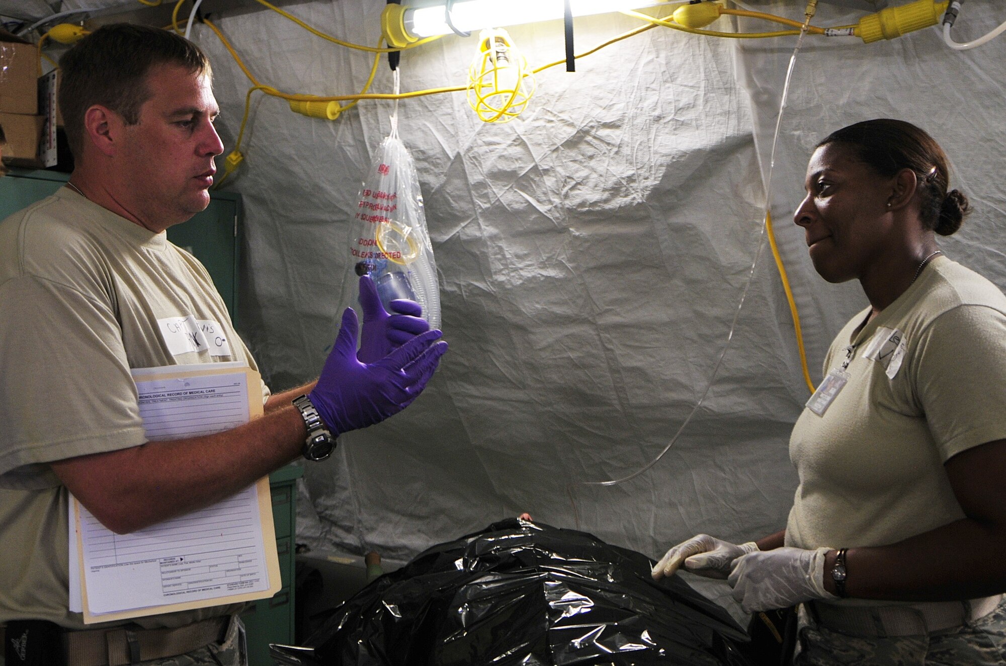 (left to right) United States Air Force Capt. Charles Purvis, an emergency room nurse, and Staff Sgt. Kamesha Lewis, a pediatric medical technician from the 48th Medical Operations Squadron from RAF Lakenheath, England, discuss the simulated medical condition of a participant of MEDCEUR 10, a medical training exercise in central and eastern Europe, at Danilovgrad Army Base, Montenegro, Sept. 15. Medical personnel from the armed forces of ten nations worked together to work through procedures that would save the lives of victims injured in a simulated gas station explosion that near a department store. For more information, visit www.usafe.af.mil/medceur.asp and www.odbrana.gov.me. (U.S. Air Force photo/Airman 1st Class Tiffany Deuel)