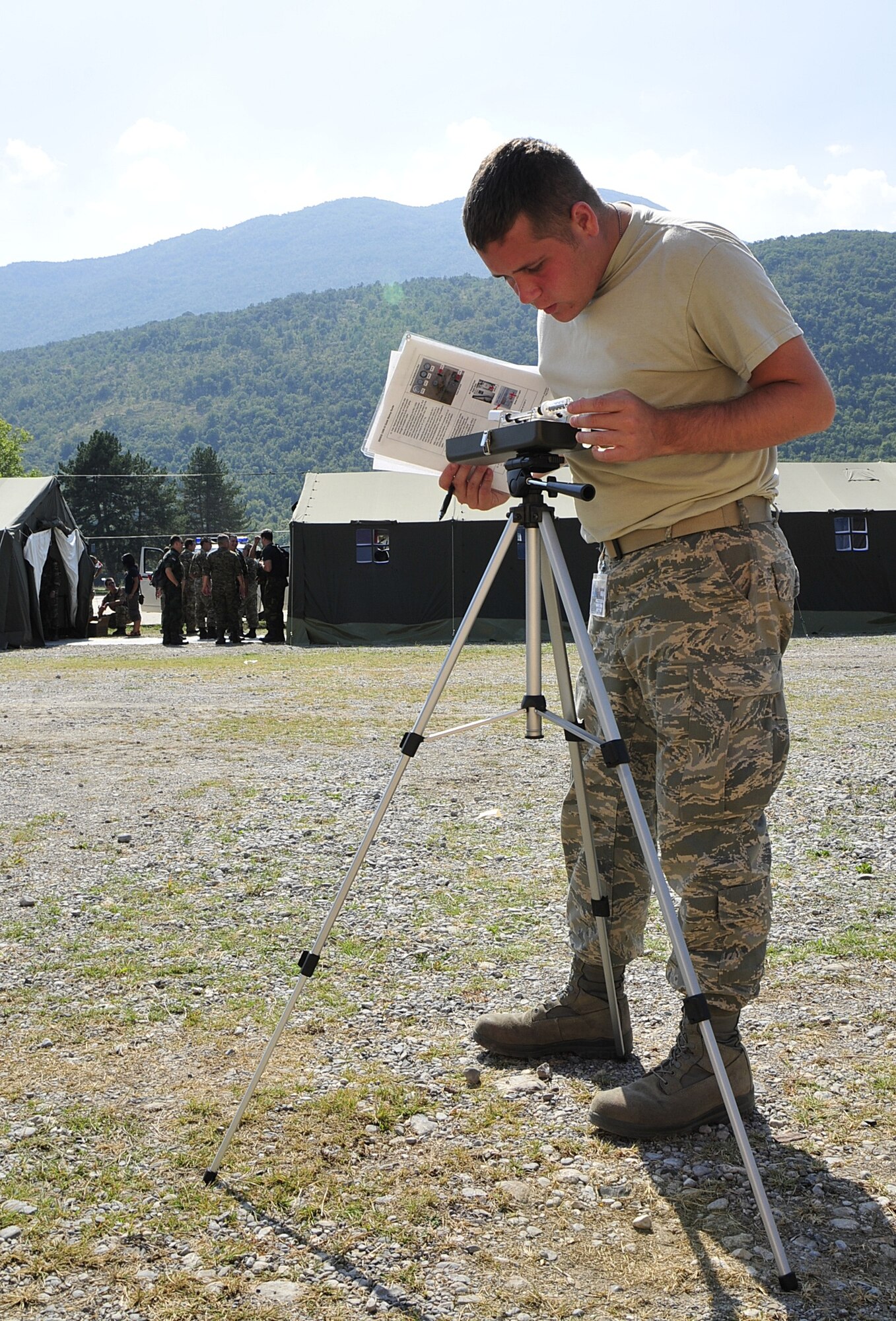 United States Air Force Senior Airman Kristopher Cocciolo, a bioenvironmental engineering technician from the 48th Aerospace Medical Squadron at RAF Lakenheath, England, checks temperature gauges during MEDCEUR 10, a medical training exercise in central and eastern Europe, at Danilovgrad Army Base, Montenegro, Sept. 15. The outdoor temperature will help Airman Cocciolo determine how often servicemembers should take breaks to cool off and hydrate. For more information, visit www.usafe.af.mil/medceur.asp and www.odbrana.gov.me. (U.S. Air Force photo/Airman 1st Class Tiffany Deuel)