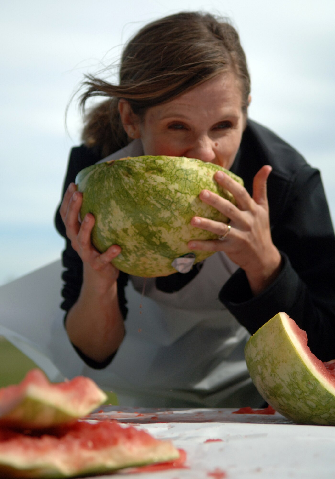Jennifer Haugen, a dietician from the Health and Wellness Center, digs in to a watermelon Sept. 16, during a watermelon eating contest at the Grand Forks Air Force Base’s commissary. The HAWC held the contest to promote the importance of eating fruits and vegetable. Nathan Bennett, 319th Force Support Squadron, won the contest after eating a half a watermelon in less than 10 minutes.  (U.S. Air Force photo by Airman 1st Class Rachel Waller)