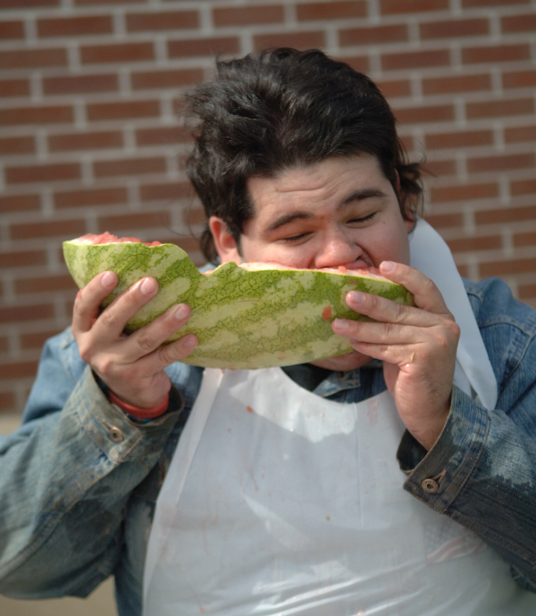 Nathan Bennett, 319th Force Support Squadron, eats watermelon Sept. 16, during a watermelon eating contest at the Grand Forks Air Force Base’s commissary Sept. 17. The HAWC held the contest to promote the importance of eating fruits and vegetable. Mr. Bennett won the contest after eating a half a watermelon in less than 10 minutes.  (U.S. Air Force photo by Airman 1st Class Rachel Waller)