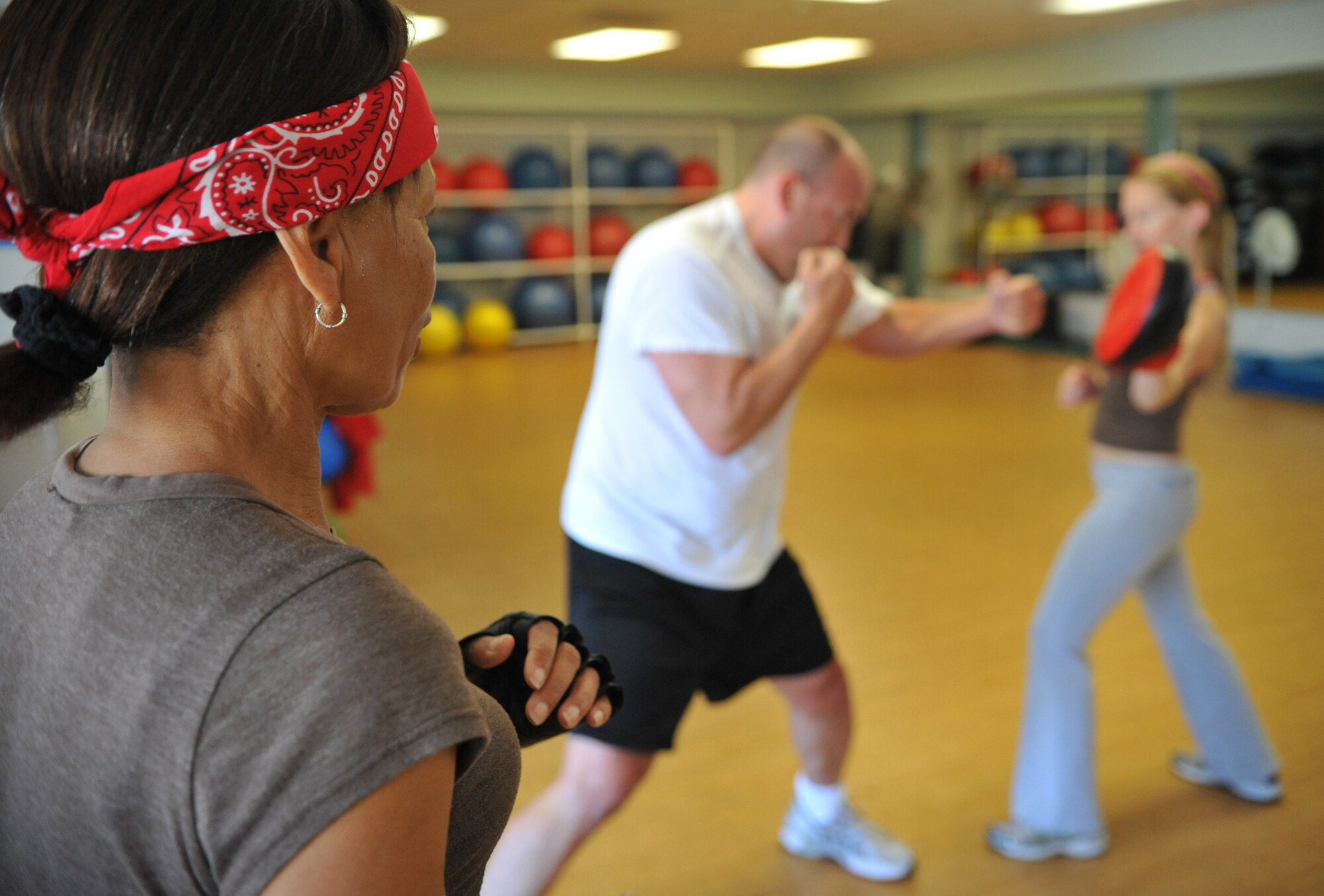 VANDENBERG AIR FORCE BASE, Calif. - Leading her class, Anita Tubbs, evaluates the moves of two members at the Cardio Kickboxing class at the Airman and Family Readiness Center here Tuesday, Sept. 14, 2010. Cardio Kickboxing is offered Tuesdays and Thursdays at noon. (U.S. Air Force photo/Senior Airman Andrew Lee)
