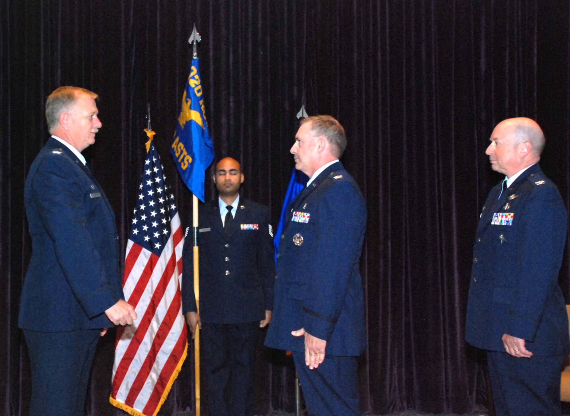 PATRICK AIR FORCE BASE, Fla. -- Colonel Robert. L. Dunn, Commander, 920th Rescue Wing (l), welcomes new Aeromedical Staging Squadron Commander Colonel Richard A. Huot (c) in a change of command ceremony held Sept. 11 in The Defense Equal Opportunity Management Institute auditorium. Colonel Lewis D. Neace, who held the position since 2004, will assume the position of Surgeon General and Director of Medical Operations 10th Air Force at Carswell Joint Reserve Base in Texas. Saving lives is at the heart of everything we do. It doesn't matter if it's a downed F-16 pilot in Iraq, astronauts who have bailed out from the space shuttle, hurricane victims stranded on rooftops or a fishermen trapped aboard a sinking ship in the Atlantic Ocean. If the 920th Rescue Wing gets the call, we're going to get them to safety. (U.S. Air Force photo/Master Sgt. Bryan Ripple)
