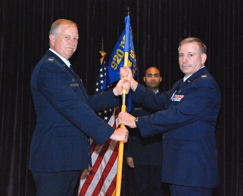 PATRICK AIR FORCE BASE, Fla. -- Col. Robert. L. Dunn, Commander, 920th Rescue Wing (l), welcomes new Aeromedical Staging Squadron Commander Col. Richard A. Huot in a change of command ceremony held Sept. 11 in The Defense Equal Opportunity Management Institute auditorium. Saving lives is at the heart of everything we do. It doesn't matter if it's a downed F-16 pilot in Iraq, astronauts who have bailed out from the space shuttle, hurricane victims stranded on rooftops or a fishermen trapped aboard a sinking ship in the Atlantic Ocean. If the 920th Rescue Wing gets the call, we're going to get them to safety. (U.S. Air Force photo/Master Sgt. Bryan Ripple)