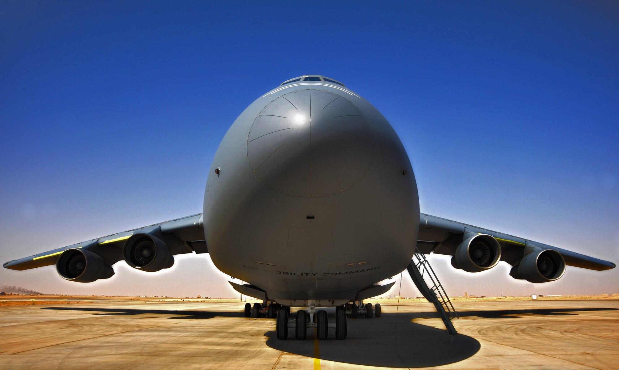 A high dynamic range photograph of a C-5 Galaxy sits on the flight line as it is prepared for a flight Sept. 13th, 2010, at Al Asad Air Base, Iraq. The C-5 is one of the largest aircraft in the world and the largest airlifter in the Air Force inventory. The C-5 can carry more than any other airlifter. It has the ability to carry 36 standard pallets and up to 81 troops simultaneously.(U.S. Air Force photo-illustration by Senior Airman Perry Aston) (Released)