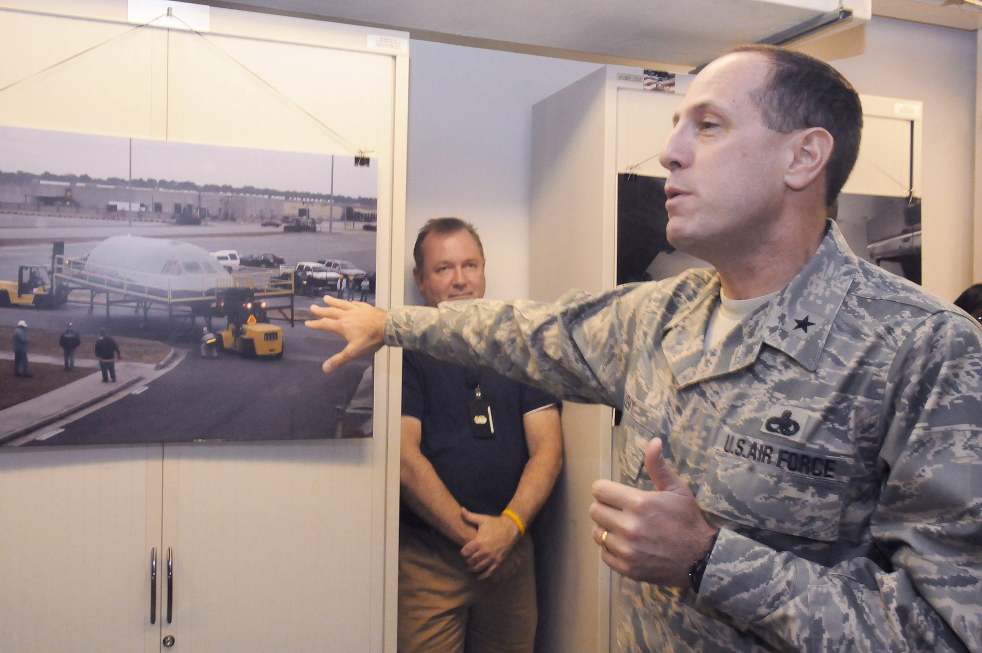 Brig. Gen. Lee Levy, the 402nd Maintenance Wing commander at Robins Air Force Base, Ga., explains the logistics of moving a C-5 cockpit section into its new facility during the opening ceremony for the building Sept. 10, 2010.  The cockpit section will be used by engineers to test software in a real environment without tying up actual C-5s. The cockpit section came from a C-5 that crashed at Dover AFB, Del., in 2006. (U.S. Air Force photo/Sue Sapp)