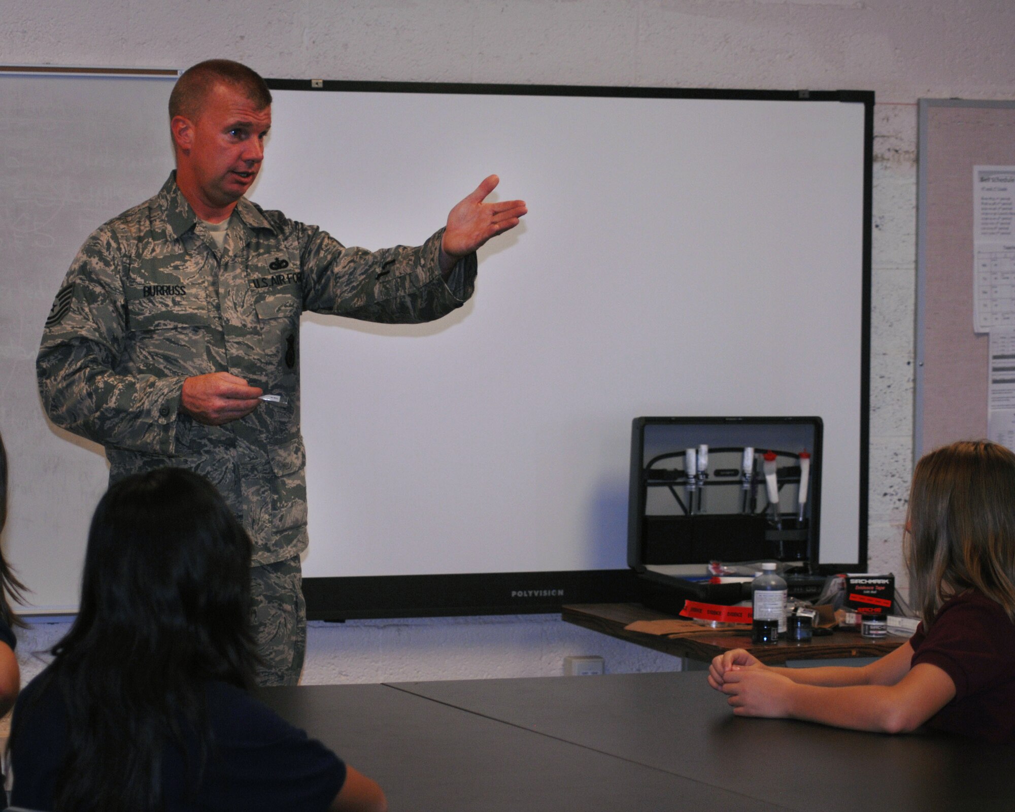 DAVIS MONTHAN AIR FORCE BASE, Ariz. - Tech. Sgt. Daniel Burruss, a security forces craftsman from the 355th Security Forces Squadron, teaches students forensic science concepts during the first week of a nine-week program held at the Sonoran Science Academy here Sept. 9, 2010. The program is held every Thursday at 4 p.m. and is open to all Sonoran Science Academy students who have a general interest in forensic science techniques. (U.S. Air Force photo/Senior Airman Shane Dunaway)