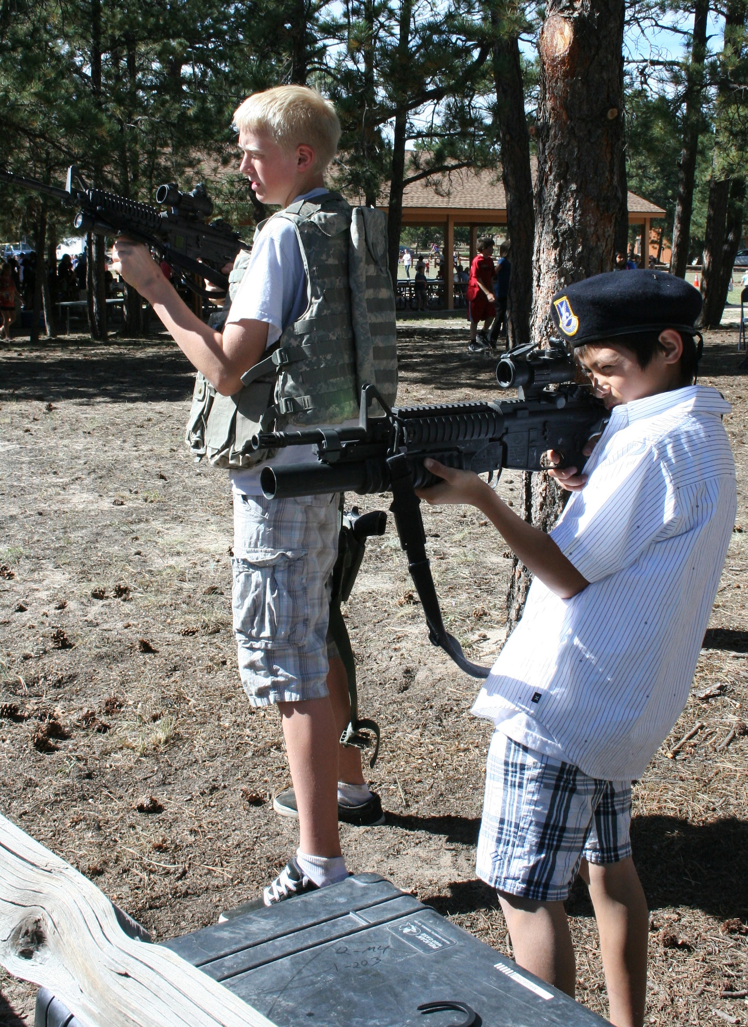 The 310th Security Forces Squadron provided Reservists and their family members the opportunity to try on some deployment gear and check out various weapons Sept. 12 at the southern units family day picnic. Various other organizations from the 310SW and U.S. Air Force Academy contributed activities during this year?s picnic. (U.S. Air Force Photo/ Staff Sgt. Desiree Economides)