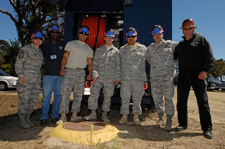 VANDENBERG AIR FORCE BASE, Calif. – Smiling for the camera, Chief Master Sgt. Angelica Johnson, 30th Space Wing command chief, and Col. Richard Boltz, 30th Space Wing commander, along with members of the 30th Civil Engineer Squadron flush out a sewage main at Cocheo Park here Thursday, Aug. 26, 2010. Colonel Boltz and Chief Johnson will be partaking in monthly in activities within Team V's work centers. (U.S. Air Force photo/Airman 1st Class Lael Huss)