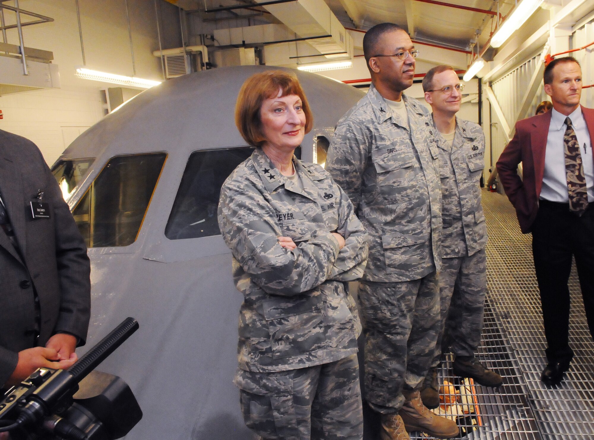 Maj. Gen. Polly Peyer, Col. Howard Davis and Col. Michael Gregg listen to a briefing during opening activities for the C-5 cockpit. U. S. Air Force photo by Sue Sapp