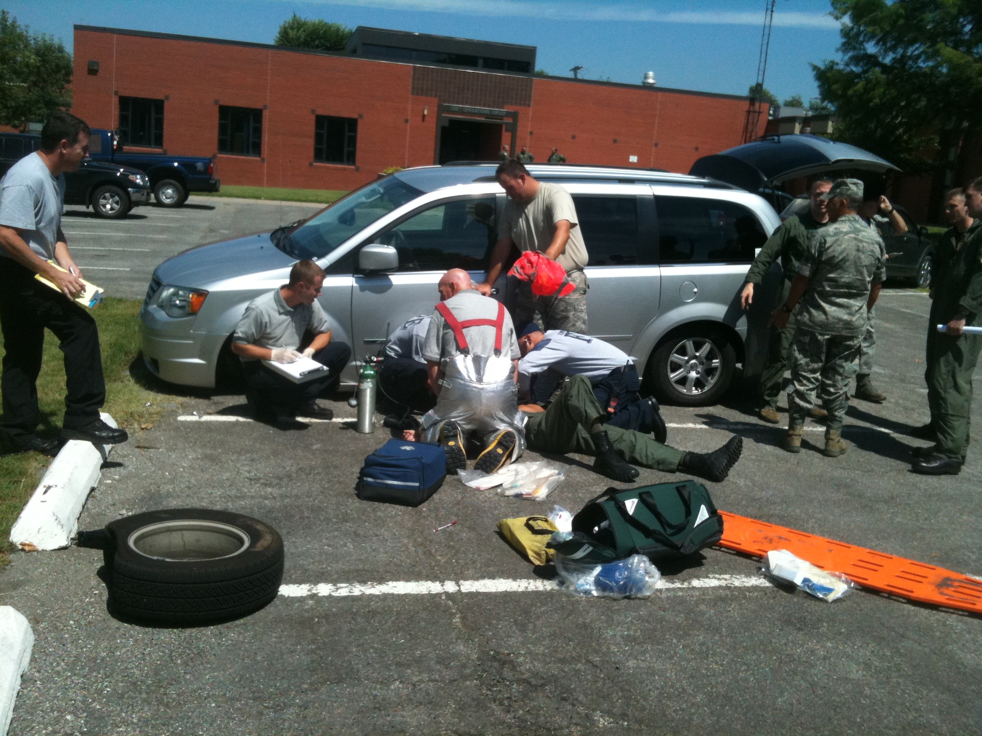 139th Airlift Wing fire department personnel respond to a Security Forces Raven after a jack gives way causing a van to fall on him while changing a tire. The Raven was transient from the 121st Security Forces Squadron, Rickenbacker Air Natinoal Guard, Ohio who escaped with only minor injuries. (U.S. Air Force photo by MSgt Shannon Bond/Released)