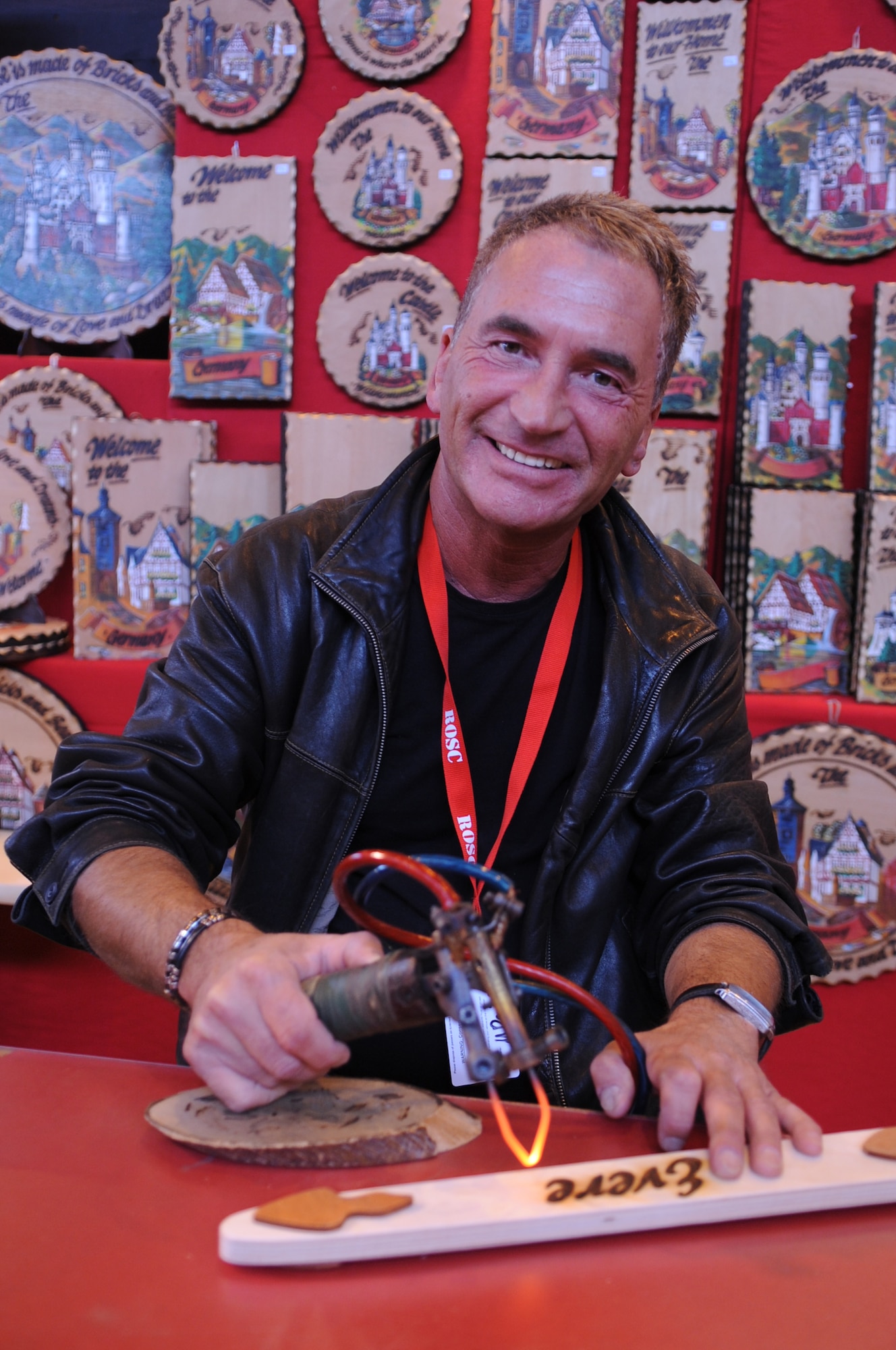 Martin Reimlinger, woodburn art vendor, displays his talent at the Ramstein Welfare Bazaar, Ramstein Air Base, Germany, Sept. 16, 2010. For more than four decades, the Kaiserslautern Military Community has benefited from the Ramstein Welfare Bazaar. This annual event dates back to 1965 and has grown into one of the largest military bazaars in Europe. (U.S. Air Force photo by Airman 1st Class Brittany Perry)