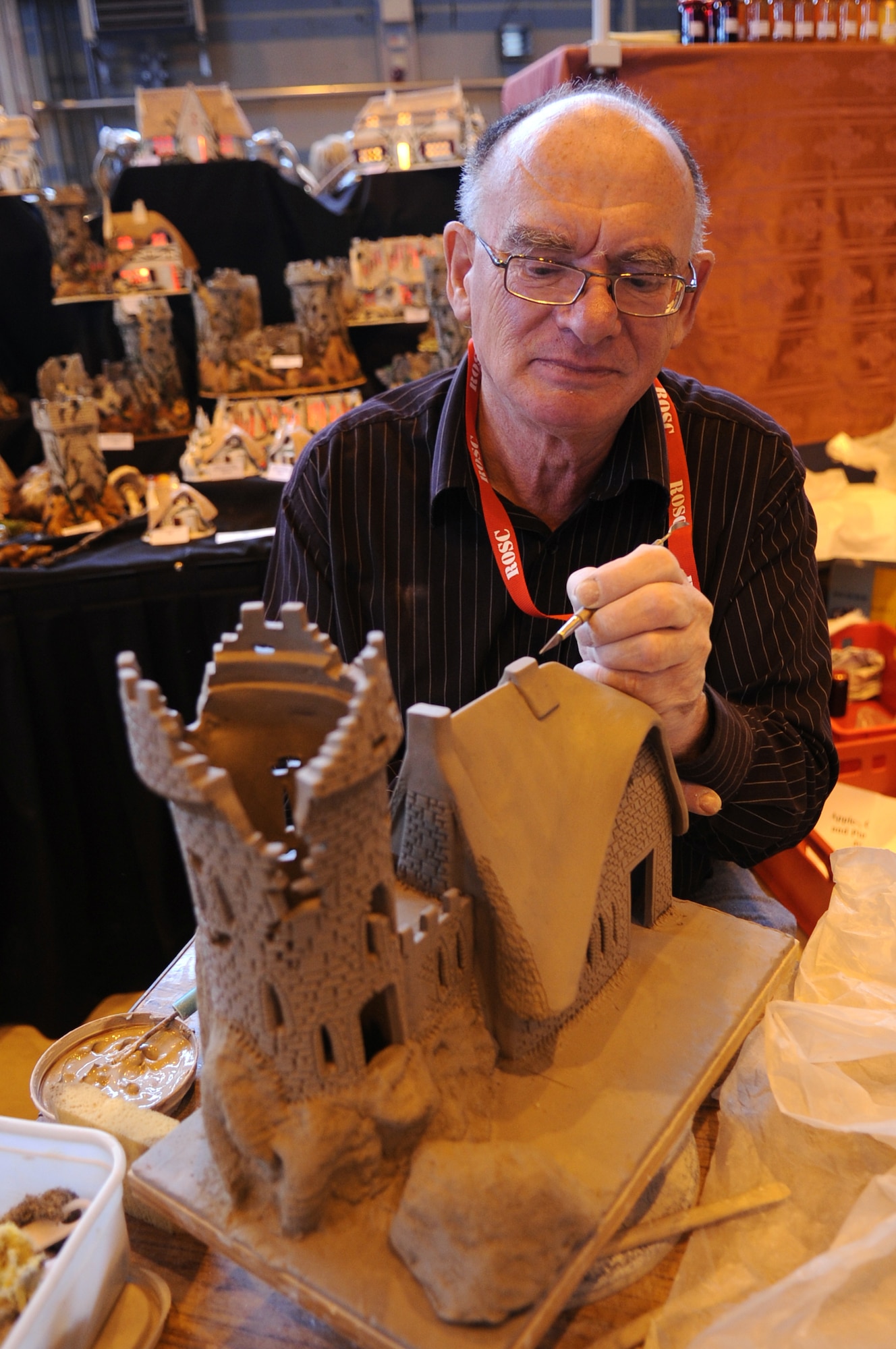Leonardo Canziani, bone china vendor, sculpts a bone china cottage at the Ramstein Welfare Bazaar, Ramstein Air Base, Germany, Sept. 16, 2010. For more than four decades, the Kaiserslautern Military Community has benefited from the Ramstein Welfare Bazaar. This annual event dates back to 1965 and has grown into one of the largest military bazaars in Europe. (U.S. Air Force photo by Airman 1st Class Brittany Perry)