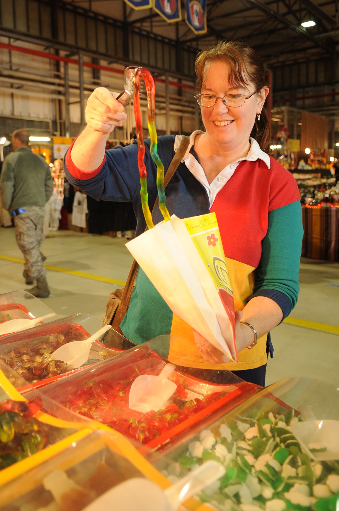 Tina Pieplow, military spouse, picks from a variety of candy while visiting the Ramstein Welfare Bazaar, Ramstein Air Base, Germany, Sept. 16, 2010. For more than four decades, the Kaiserslautern Military Community has benefited from the Ramstein Welfare Bazaar. This annual event dates back to 1965 and has grown into one of the largest military bazaars in Europe. (U.S. Air Force photo by Airman 1st Class Brittany Perry)