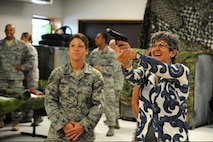 Staff Sgt. Jessica McDonald, 22nd Security Forces Squadron unit trainer, watches as Susan Allardice, wife of Lt. Gen. Robert Allardice, 18th Air Force commander, tries a Beam Hit System, at the combat skills training facility, McConnell Air Force Base, Kan., Sept. 8, 2010.  A Beam Hit System is a training simulator that uses laser-mounted weapons and a video screen to simulate situations where deadly force might be necessary.  Mrs. Allardice visited key facilities and members of McConnell to familiarize herself with base practices and available services for military members and their families.  (U.S. Air Force photo/Staff Sgt. Dallas Edwards)