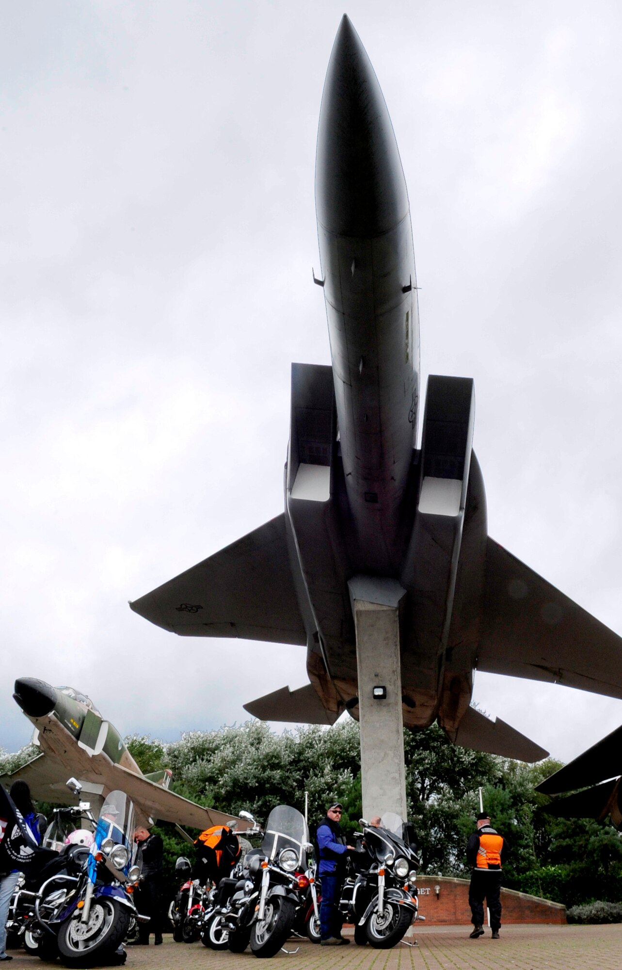 RAF MILDENHALL, England -- Members of the Rolling Thunder Motorcycle Rally park their bikes under the static displays of the "Lest we Forget" wall at RAF Lakenheath to conclude the Prisoner of War/Missing in Action ride Sept. 14. The Rolling Thunder Motorcycle Rally is just one of several events scheduled for POW/MIA Remembrance Week. (U.S. Air Force photo/Senior Airman Ethan Morgan)