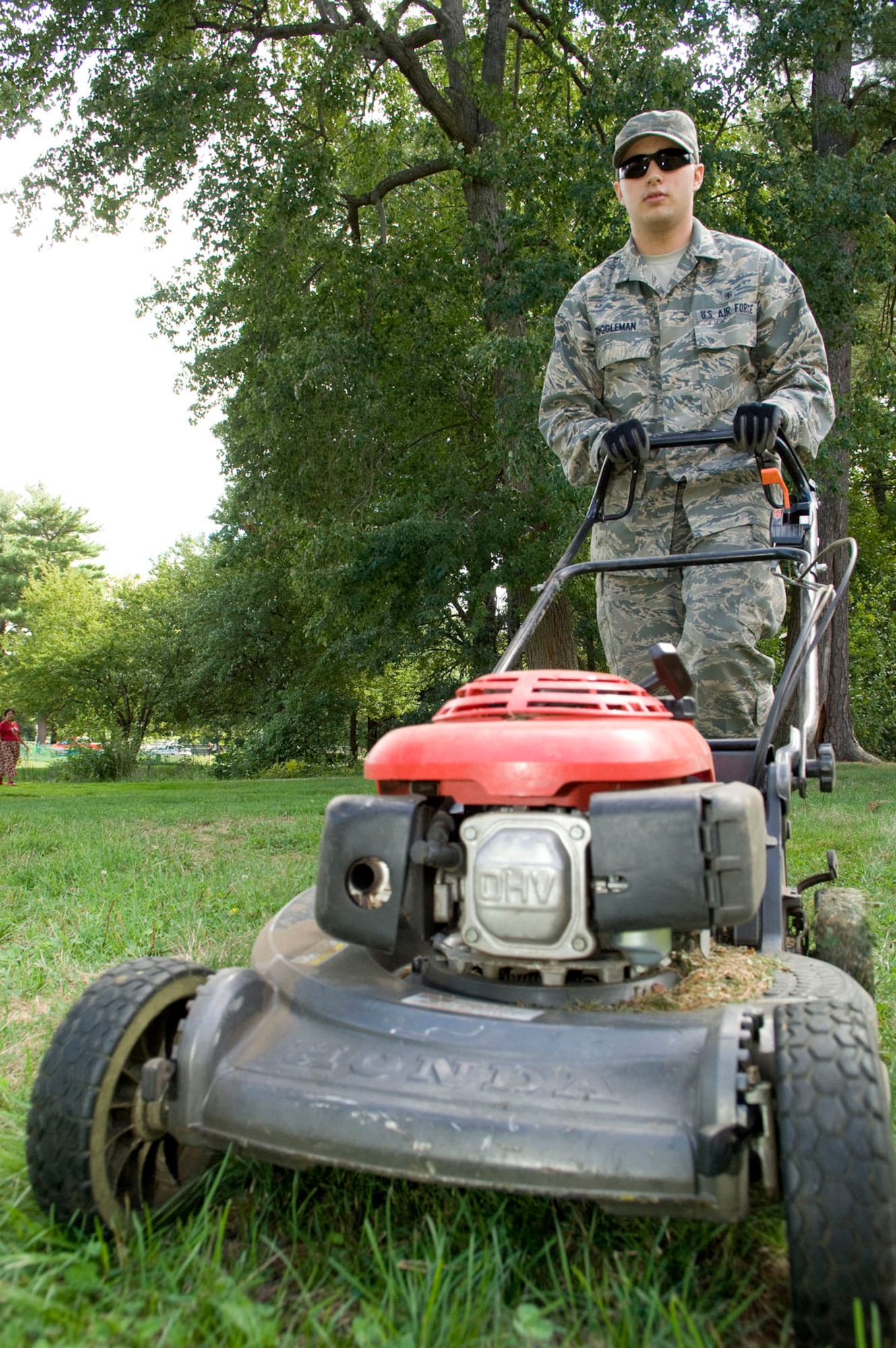 HANSCOM AIR FORCE BASE, Mass. – Senior Airman Richard Riggleman, from the 66th Medical Squadron, mows a small area near Castle Park at Marrett Street on Sept. 10. Sixteen Airmen dedicated their day to mowing common areas to improve the base’s appearance. (U.S. Air Force photo by Mark Wyatt)