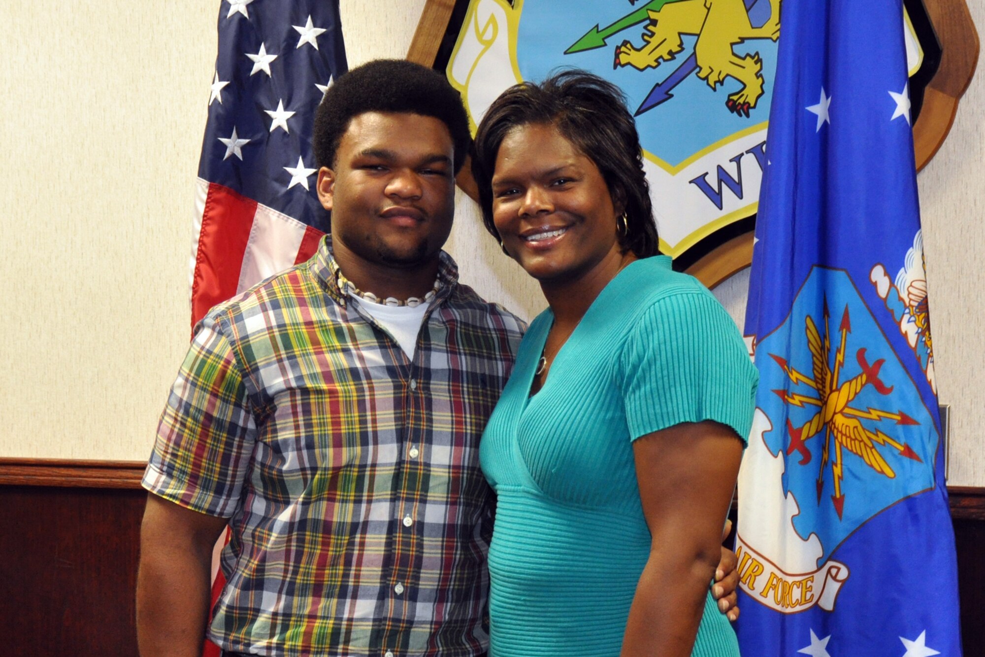 Brandon Roynell Curry poses with his mother, Saundra Denise Williams after enlisting in the Air Force Reserves at Barksdale Air Force Base, La., Sept. 11, 2010. Curry is a student at Bossier Parish Community College taking general courses until he leaves for Basic Military Training and technical training. Upon completion of his basic and technical training, Curry will return to Barksdale as an Electrical Systems Apprentice for the 917th Wing. (U.S. Air Force photo/Tech. Sgt. Jeff Walston)