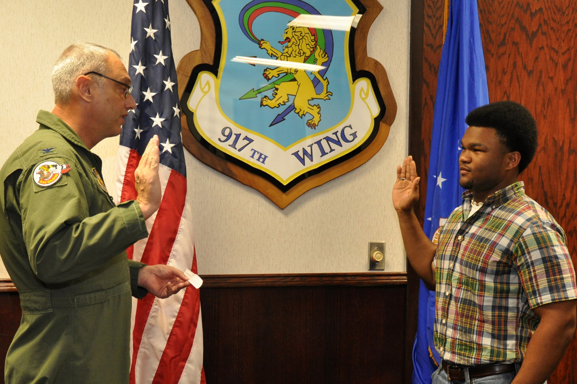 Col. John J. Mooney III, commander of the 917th Wing at Barksdale Air Force Base, La., administers the oath of enlistment to Brandon Roynell Curry Sept. 11, 2010. Curry is a student at Bossier Parish Community College taking general courses until he leaves for Basic Military Training. Upon completion of his basic and technical training, Curry will return to Barksdale as an Electrical Systems Apprentice for the 917th Wing. (U.S. Air Force photo/Tech. Sgt. Jeff Walston)