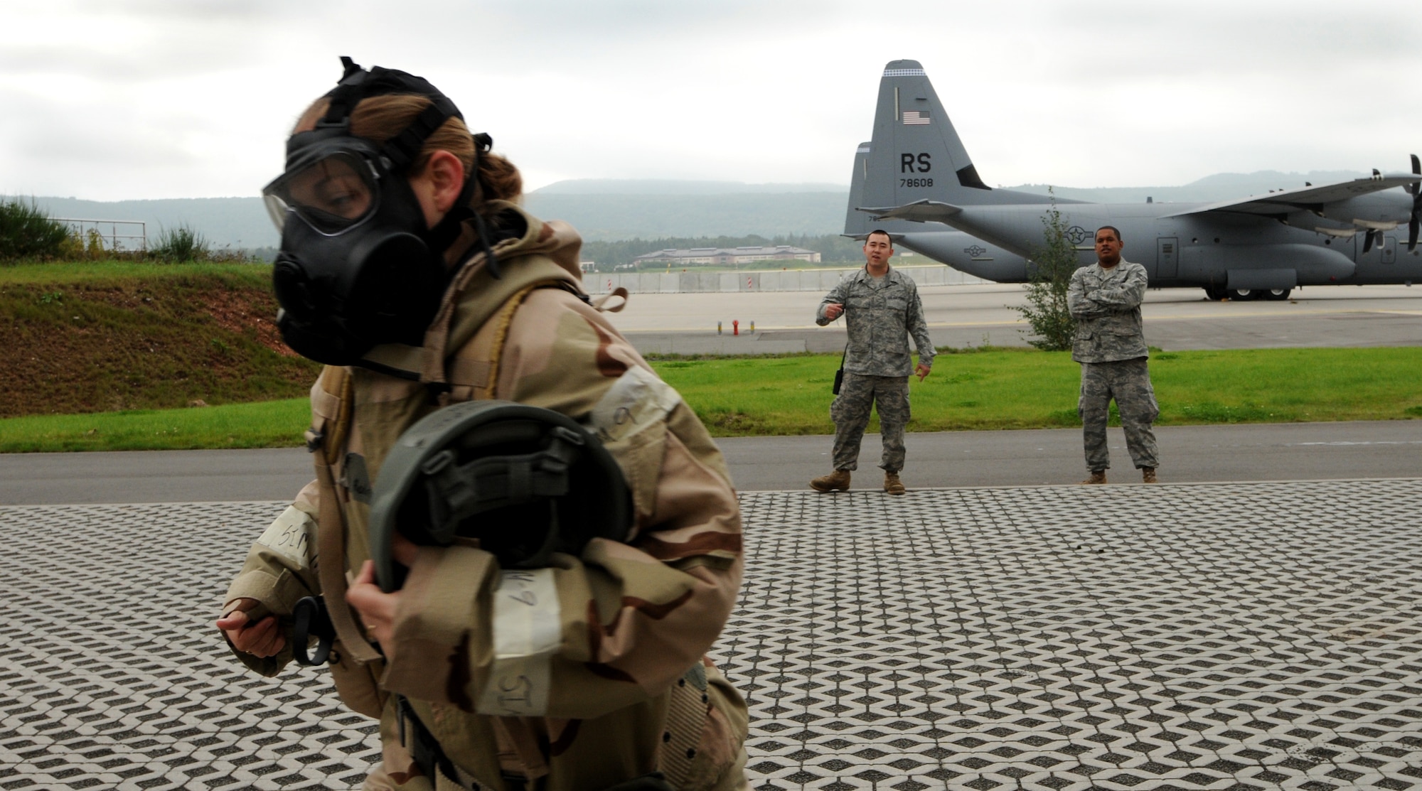 U.S. Air Force Tech. Sgt. Misti Rodriguez, 86th Maintenance Operations Squadron training manager, runs in chemical gear during a simulated unexploded ordinance explosion. The 86th Aircraft Maintenance Group has practiced for the upcoming Operation Readiness Inspecting since December. (U.S Air Force photo by Airman 1st Class Ciara M. Travis)
