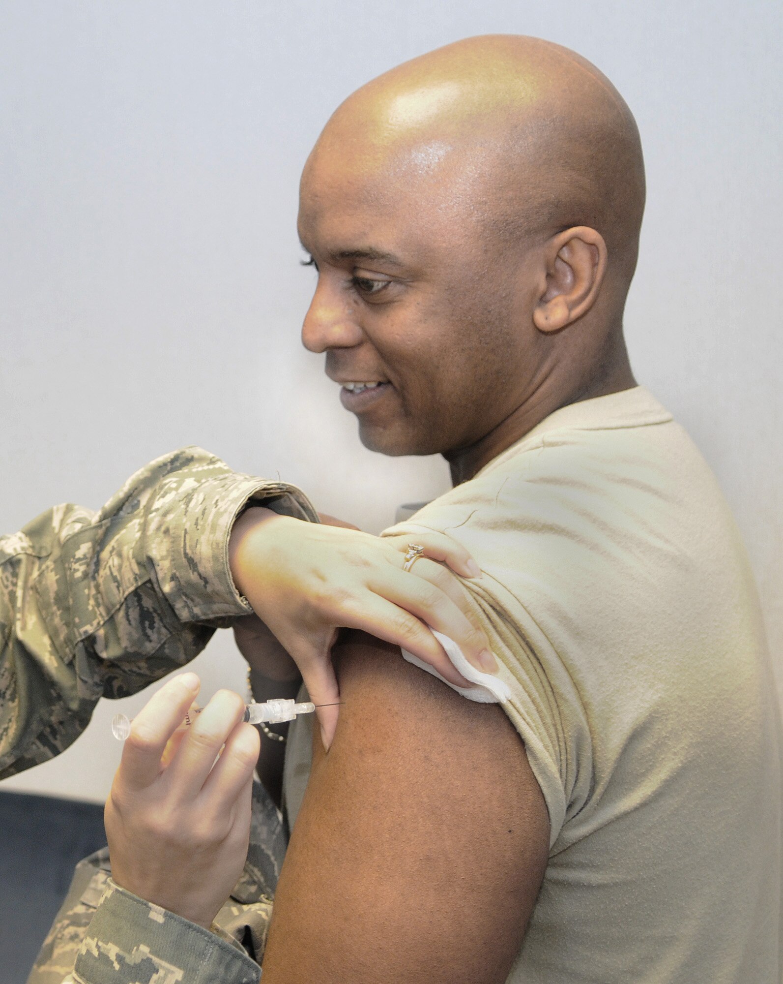 RAF MILDENHALL, England -- Senior Master Sgt. Joseph Watkins, 100th Comptroller Squadron, receives the flu vaccine in the 100th Mission Support Group conference room Sept. 15. This innoculation is required annually for all active duty Airmen. It is currently also being offered by the RAF Lakenheath hospital to any high risk dependents, which includes anyone with asthma, children under 2 and anyone over 50. For more information, contact the 48th Medical Group Immunization Clinic at DSN 238-8010. (U.S. Air Force photo/Staff Sgt. Thomas Trower)