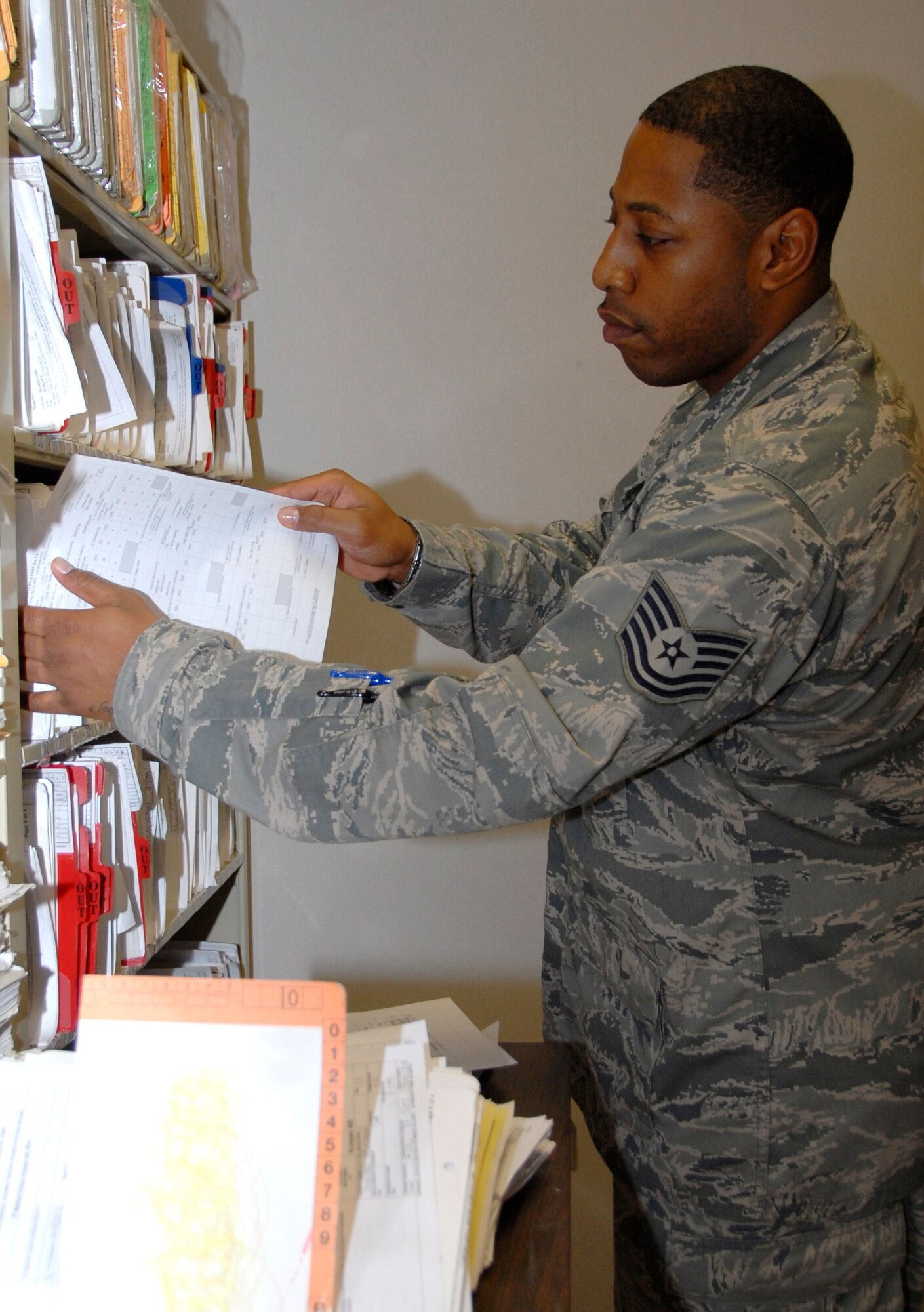 KUNSAN AIR BASE, Republic of Korea -- Tech. Sgt. Daniel Johnson, 8th Medical Support Squadron NCO in charge of records, files records by terminal-digit order. The outpatient records element is part of the 8th MDSS business operations and beneficiary information systems flight. (U.S. Air Force photo/Staff Sgt. Amanda Savannah)