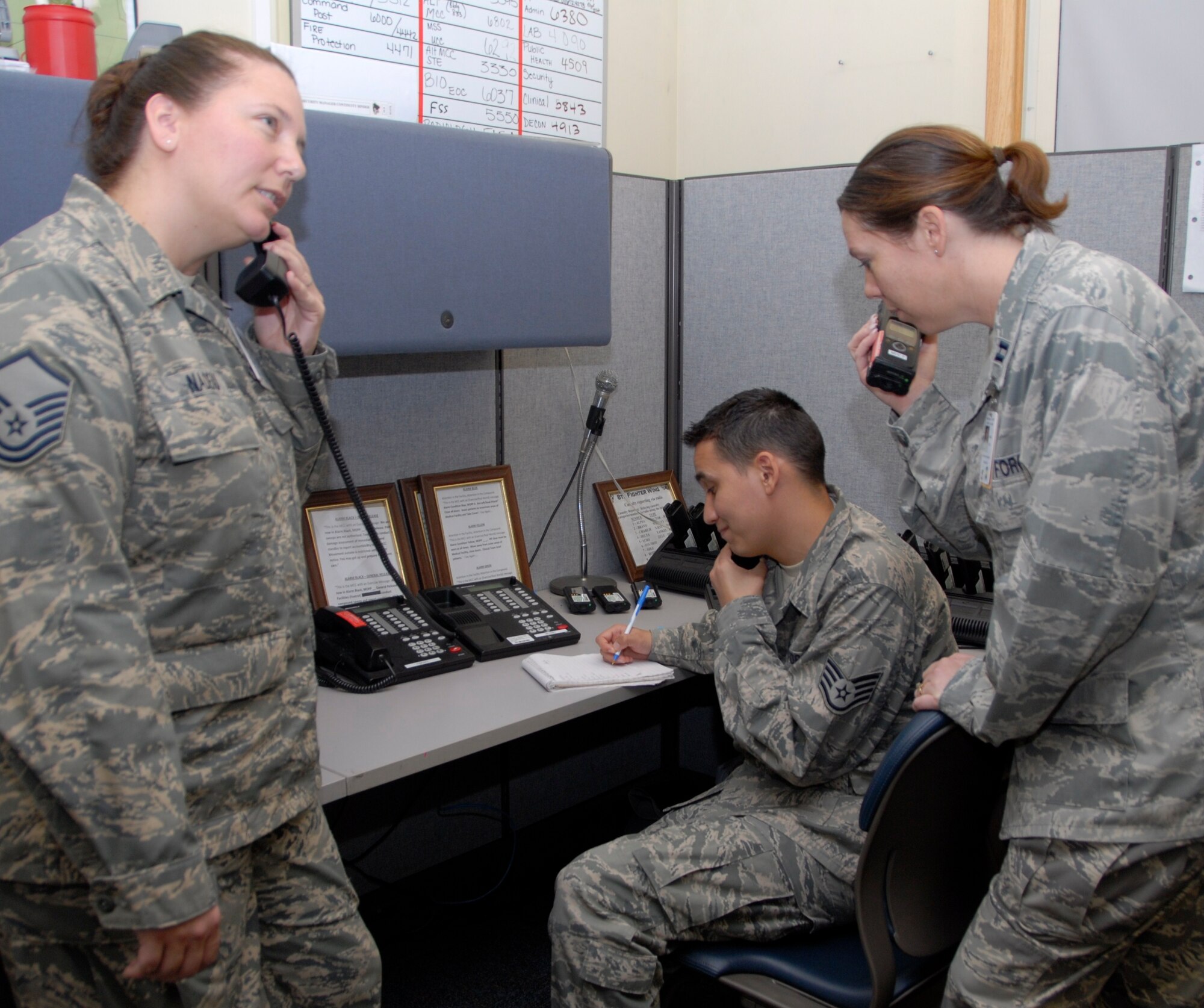 KUNSAN AIR BASE, Republic of Korea -- Master Sgt. Mary Nadeau, 8th Medical Support Squadron medical readiness flight chief, Staff Sgt. Chris Standage, 8th MDSS unit deployment manager, and Capt. Stacy Fackelman, 8th MDSS medical readiness flight commander, man the squadron's unit control center during exercises and real world contingencies. The medical readiness element is part of the 8th MDSS business operations and beneficiary information systems flight. (U.S. Air Force photo/Staff Sgt. Amanda Savannah)