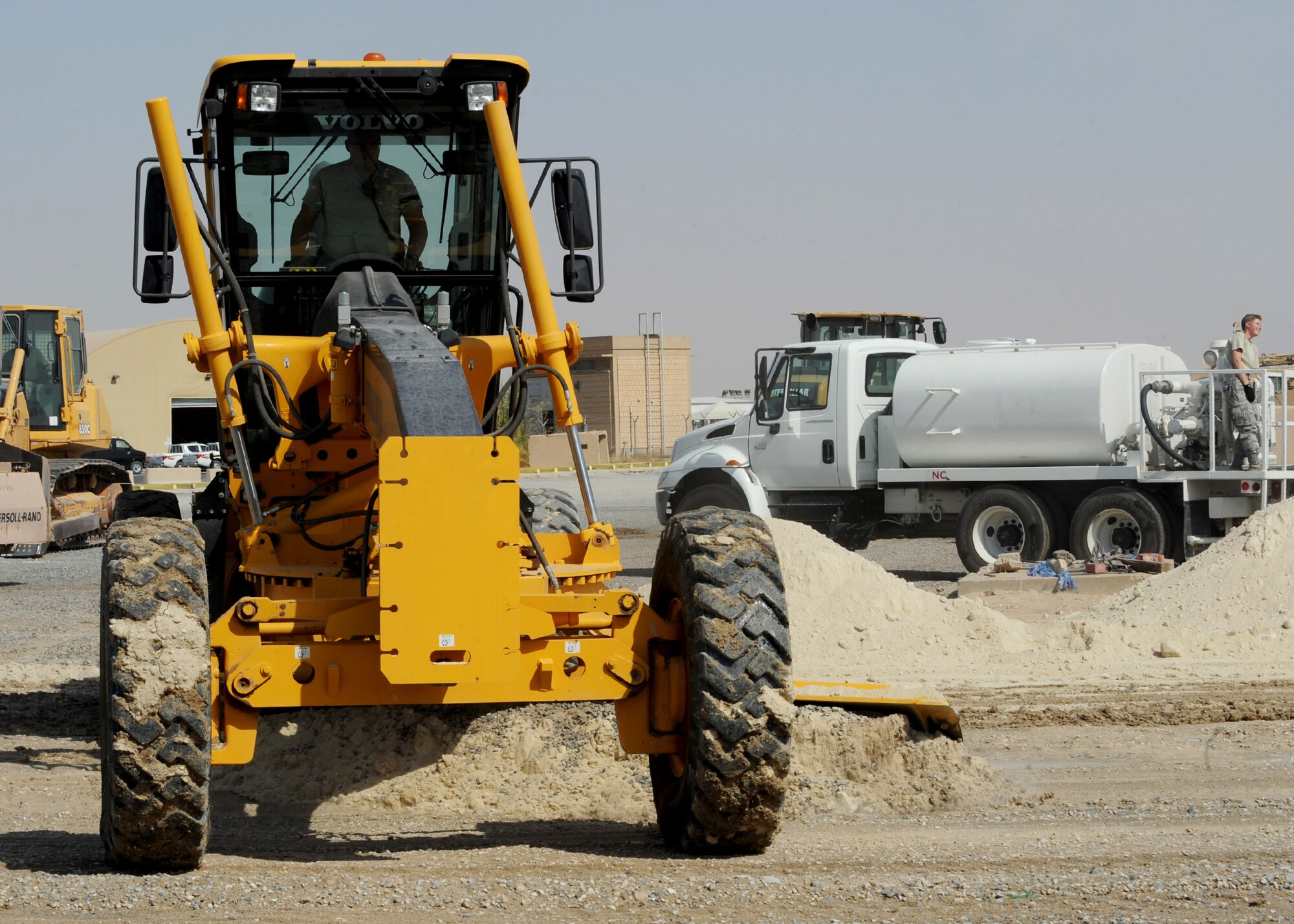 SOUTHWEST ASIA - Tech. Sgt. David S. Krisher, 386th Expeditionary Civil Engineer Squadron, levels sand with an excavator in preparation to lay asphalt at an undisclosed air base here Sept. 8, 2010. CE is responsible for facility maintenance, airfield paving, explosive ordinance disposal and environmental management. (U.S. Air Force photo by Senior Airman Laura Turner)