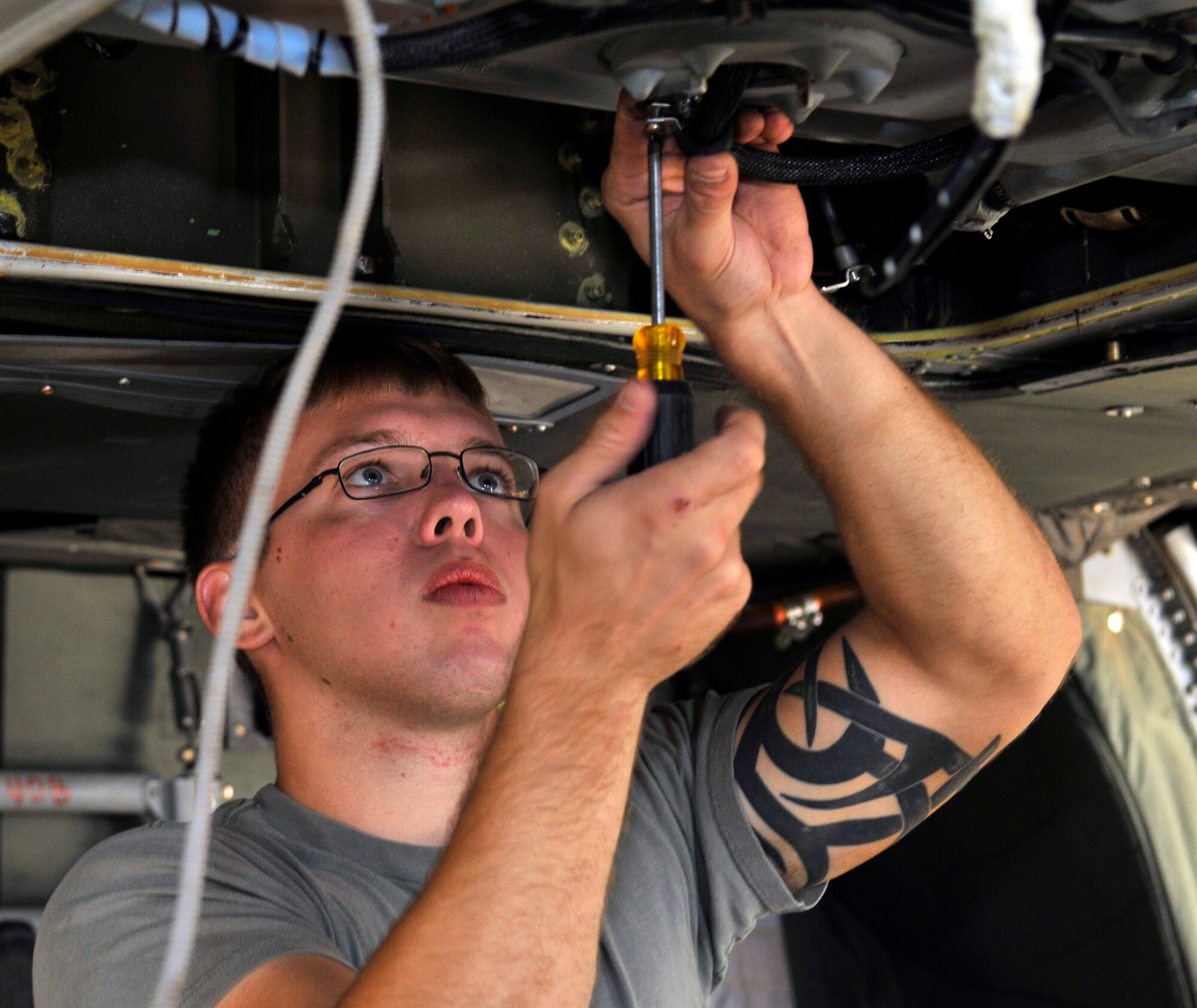 Army Pfc. Cody Hunt, Charlie Company, 7th Battalion, 101st Aviation Regiment crew chief, attaches an anti-icing wire harness to a UH-60 Black Hawk sump after a transmission replacement Sept. 10, 2010, Joint Base Balad, Iraq. The UH-60 Black Hawk is a four-bladed, twin-engine, medium-lift utility helicopter. Private Hunt, is a native of Pickens County, Ga., deployed from Fort Campbell, Ky. (U.S. Air Force photo/Staff Sgt. Phillip Butterfield)