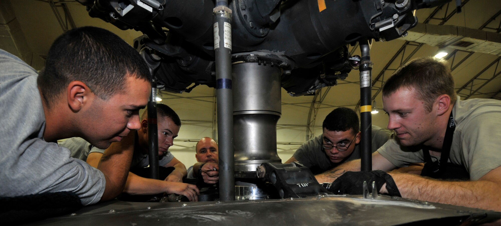 Soldiers of the Charlie Company, 7th Battalion, 101st Aviation Regiment, torque and measure a swash-plate to the main rotor on a UH-60 Black Hawk after a transmission replacement Sept. 10, 2010, Joint Base Balad, Iraq.  The 18-bolt assembly must be precisely installed or the main rotor will wobble as it spins. The soldiers are all deployed from Fort Campbell, Ky. (U.S. Air Force photo/Staff Sgt. Phillip Butterfield)