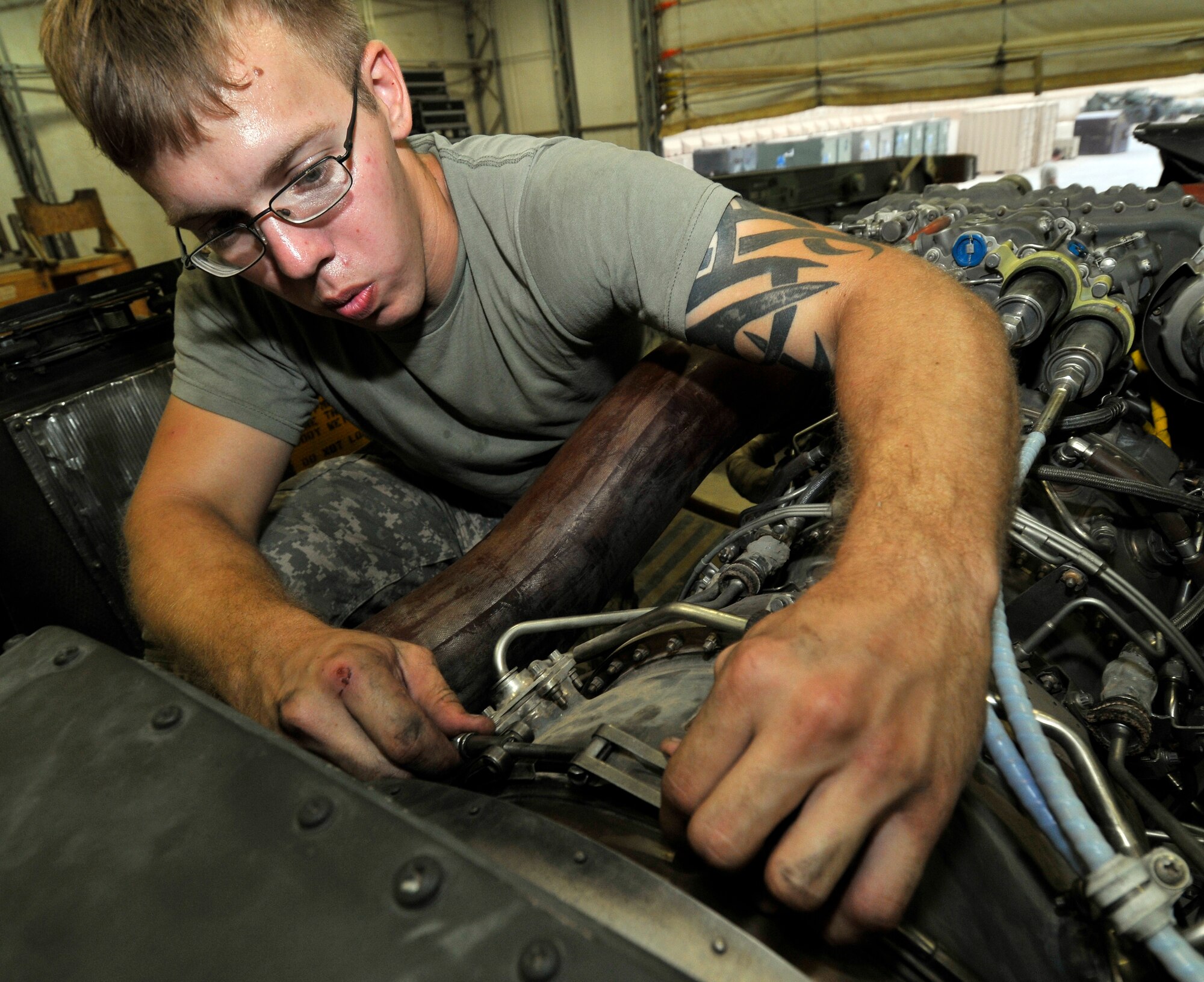 Army Pfc. Cody Hunt, Charlie Company, 7th Battalion, 101st Aviation Regiment crew chief, connects the engine with the deswirl duct after a UH-60 Black Hawk transmission replacement Sept. 9, 2010, Joint Base Balad, Iraq. The deswirl duct is an extension of the engine that helps channel hot exhaust away from the helicopter. Private Hunt is a native of Pickens County, Ga., deployed from Fort Campbell, Ky. (U.S. Air Force photo/Staff Sgt. Phillip Butterfield)