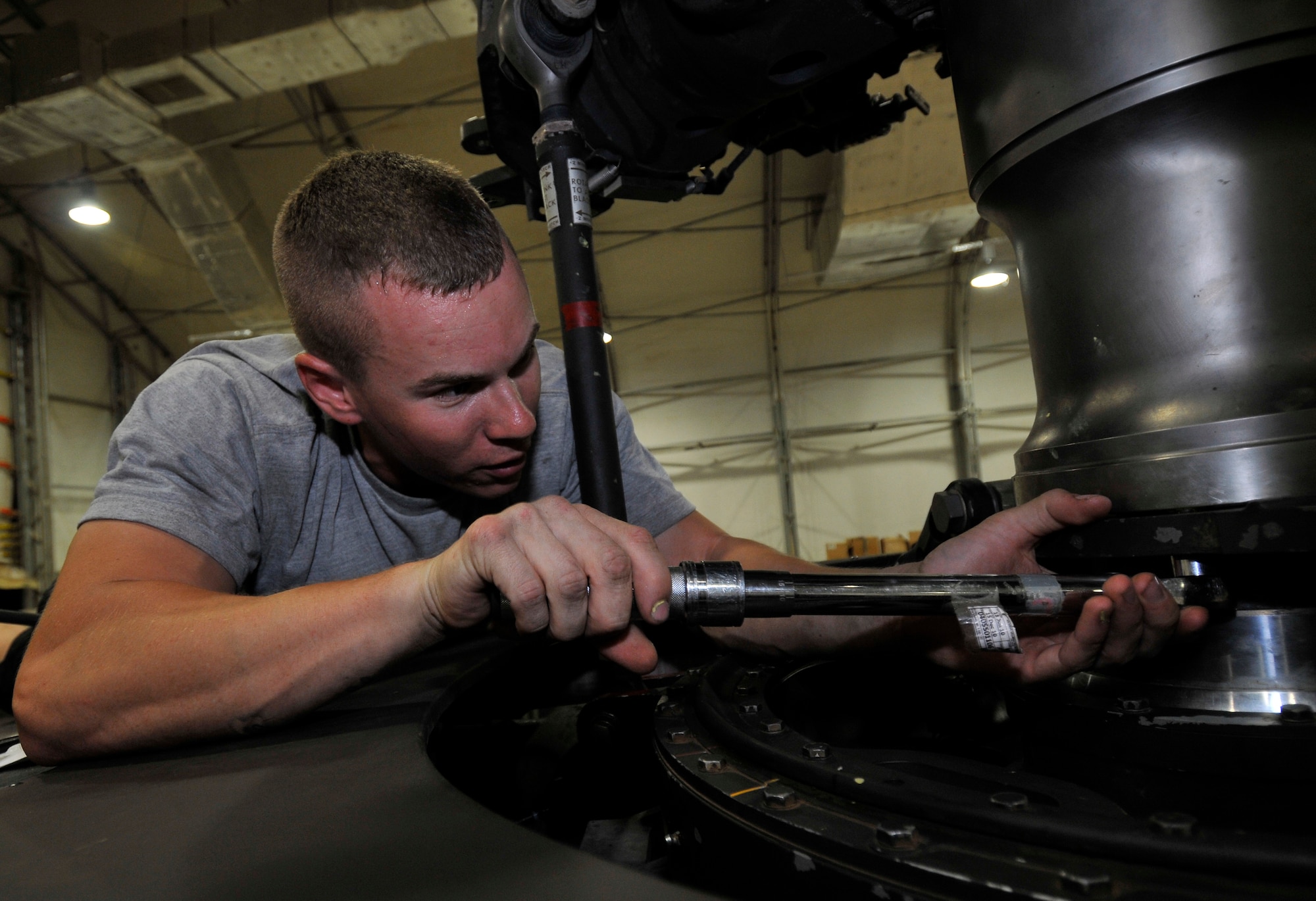 Army Sgt. Christopher Bergendahl, Charlie Company, 7th Battalion, 101st Aviation Regiment crew chief, torques bolts that hold the main rotor shaft to the swash-plate on a UH-60 Black Hawk after a transmission replacement Sept. 9, 2010, Joint Base Balad, Iraq. Helicopters use swash-plates to control the pitch angles of the main rotor blades. Sergeant Bergendahl is a native of Enfield, Conn., deployed from Fort Campbell, Ky. (U.S. Air Force photo/Staff Sgt. Phillip Butterfield)