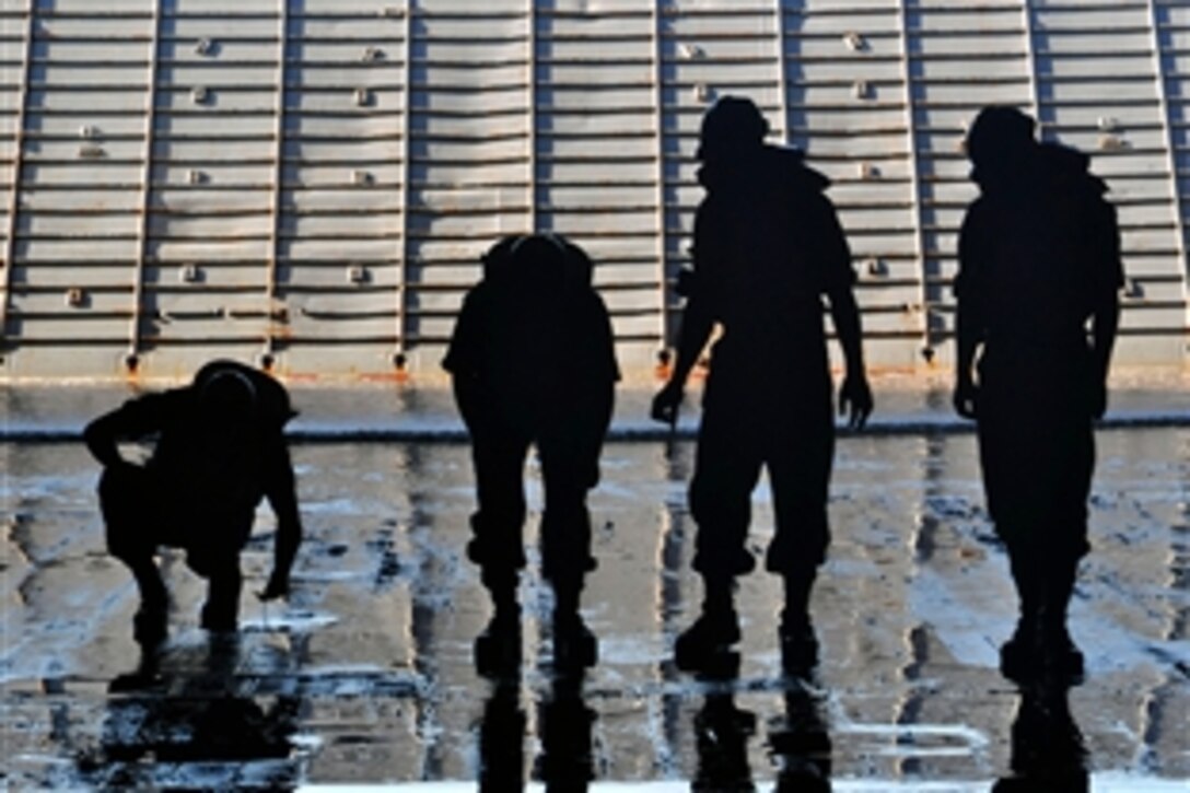 U.S. Navy sailors conduct a foreign object debris walkdown in the well deck of the amphibious transport dock ship USS Denver in preparation to recover a landing craft air cushion in the Pacific Ocean, Sept. 10, 2010. 