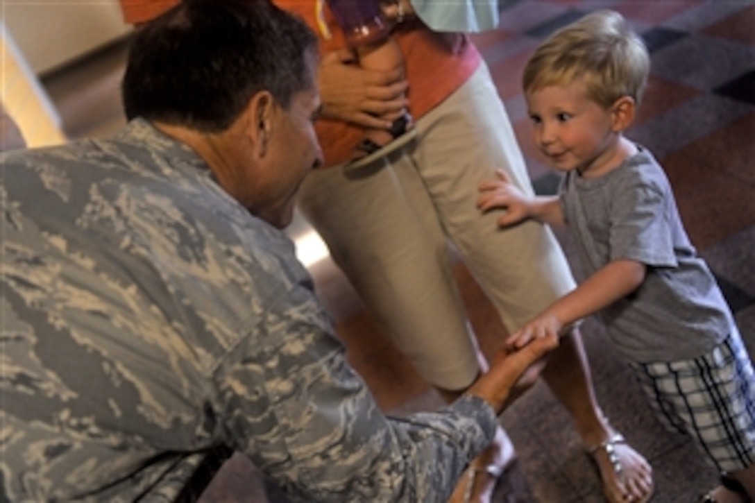 Air Force Maj. Gen. David Goldfein greets Noah Kunkel, the son of Air Force Lt. Col. Tom Kunkel, during a visit to Moody Air Force Base, Ga., Sept. 2, 2010. Goldfein was rescued by Kunkel when his aircraft was shot down over enemy territory in May 1999. Goldfein is the Air Combat Command director of air and space operations. Kunkel is the 41st Rescue Squadron commander.
