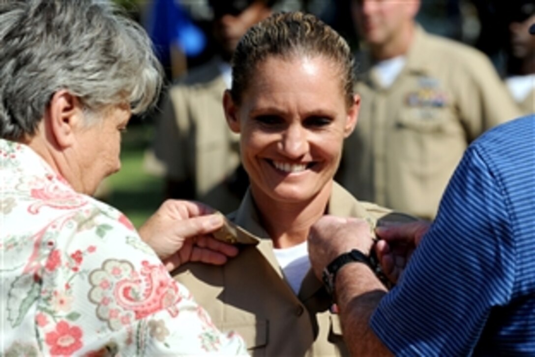 U.S. Navy Chief Petty Officer Dawn Slayton has her anchors pinned on during a pinning ceremony for new Navy chief petty officers at the Washington Navy Yard, Washington, D.C., Sept. 16, 2010.