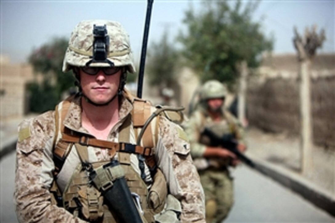 U.S. Marine Corps Lance Cpl. Jared Slattery walks on patrol near the Sangin Bazaar in Afghanistan, Sept. 15, 2010. The Marines joined forces with British 40 Commandos to conduct security patrols throughout the Sangin district. Slattery is an infantryman assigned to the Police Mentoring Team, 3rd Battalion, 7th Marine Regiment.
