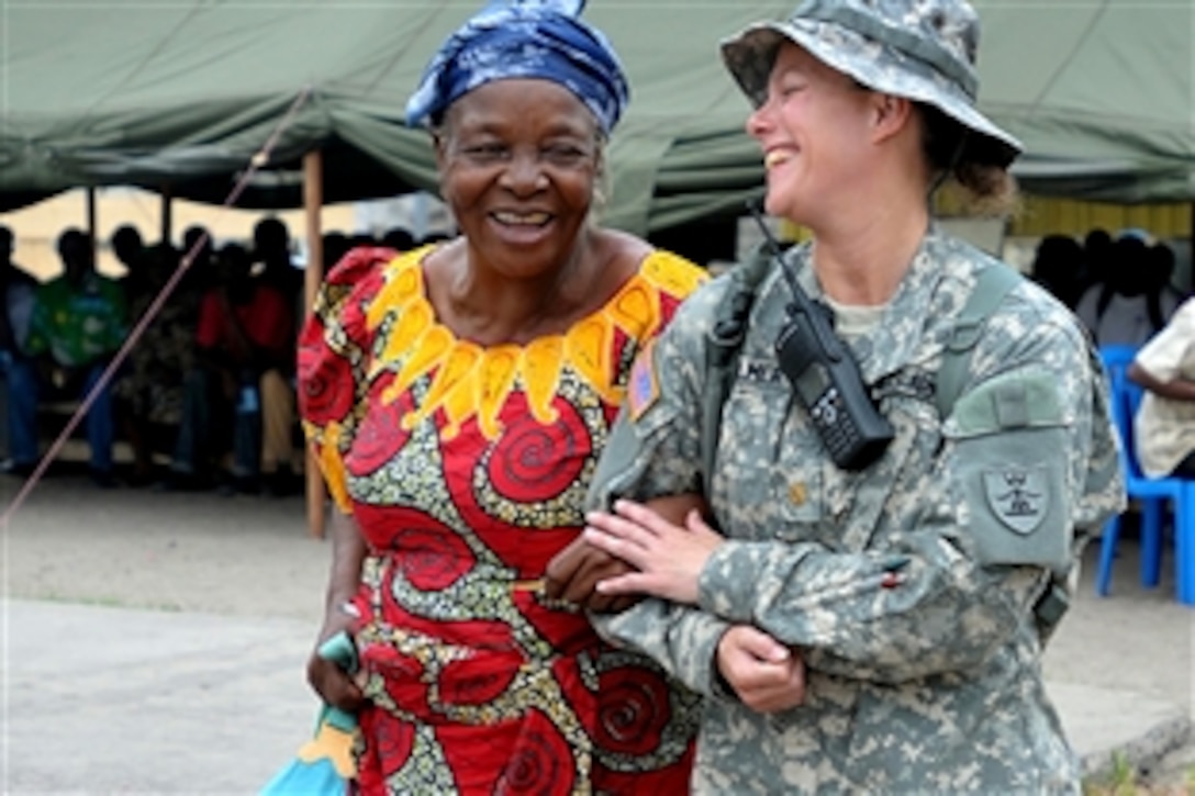 U.S. Army Maj. Angie Allmer assists a Congo resident to the medical waiting area in Kinshasa, Congo, Sept. 14, 2010. Allmer is part of a joint medical effort with U.S. military medical personnel and Congo armed forces providing humanitarian assitance to the local people. Allmer is a nurse assigned to the North Dakota National Guard's state medical detachment in Bismarck.

