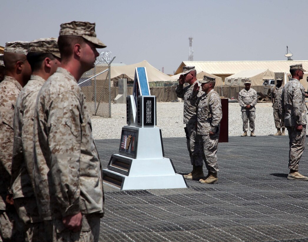 Brigadier Gen. Joseph Osterman, 1st Marine Division (Forward) commanding general, and Sgt. Maj. Phillip A. Fascetti, 1st MarDiv(Fwd) sergeant major, render a salute during a Colors and Memorial Dedication ceremony held aboard Camp Leatherneck, Afghanistan, Sept. 16, 2010. Brig.::r::::n::Gen. Osterman was presiding over the official opening of a memorial monument set up to honor the fallen heroes of 1st Marine Division, since the division took over the as the ground combat element in Helmand province in March.