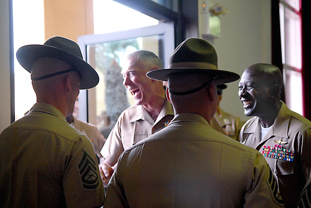 After his town hall meeting at the depot theater the Commandant of the Marine Corps, Gen. James T. Conway and Sergeant Major of the Marine Corps, Sgt. Maj. Carlton W. Kent, meet and shake hands with drill instructors while exchanging a few laughs before heading over to the Command Museum’s courtyard to address the families gathered for the graduating Marines of Company F, Sept. 16.