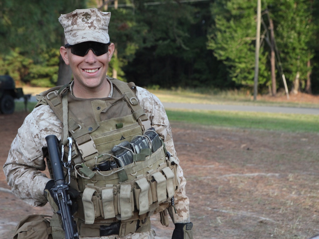 Lance Cpl. Ryan A. McCauley flashes a smile and poses for the camera before getting in line to throw M69 practice grenades at the Hand Grenade Qualification Course, here, recently.  McCauley, a team leader with Weapons Company, 2nd Battalion, 8th Marine Regiment, is training to go back to Afghanistan for a second time.