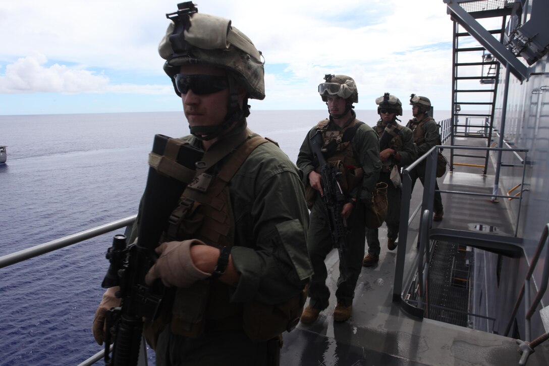 September 17, 2010, U.S. Marines with the Maritime Raid Force, 1st Battalion, 7th Marine Regiment, Battalion Landing Team, 31st Marine Expeditionary Unit, move to security positions during a Visit, Board, Search, and Seizure (VBSS) exercise aboard the U.S. Navy Ship Alan Shepard in support of exercise Valiant Shield, which is part of a certification exercise conducted by the 31st MEU.