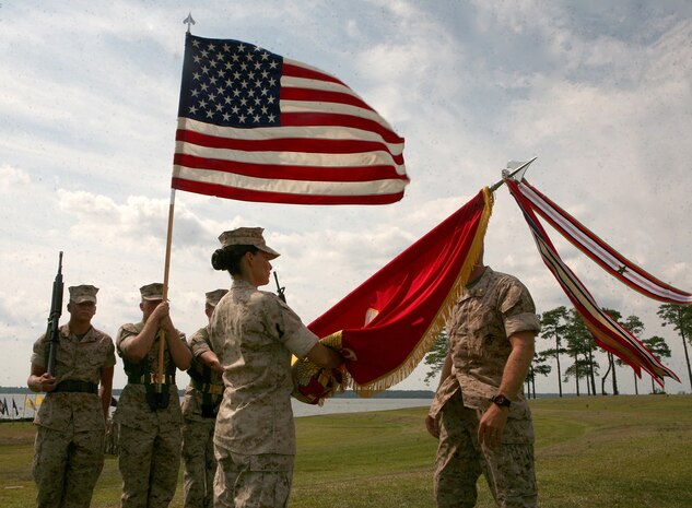 First Sgt. Raquel Painter (center), the battalion sergeant major for Combat Logistics Battalion 6, 2nd Marine Logistics Group, raises the battalion colors after Maj. William Stophel, the commanding officer for CLB-6, 2nd MLG, attached the Afghanistan Campaign Battle Streamer during the change of command and battle streamer ceremony here, Sept. 17. The steamer is displayed with the unit colors to indicate the battalion’s honorable and faithful service while deployed to Afghanistan’s Helmand province earlier this year. (U.S. Marine Corps photo by Sgt. Justin J. Shemanski)