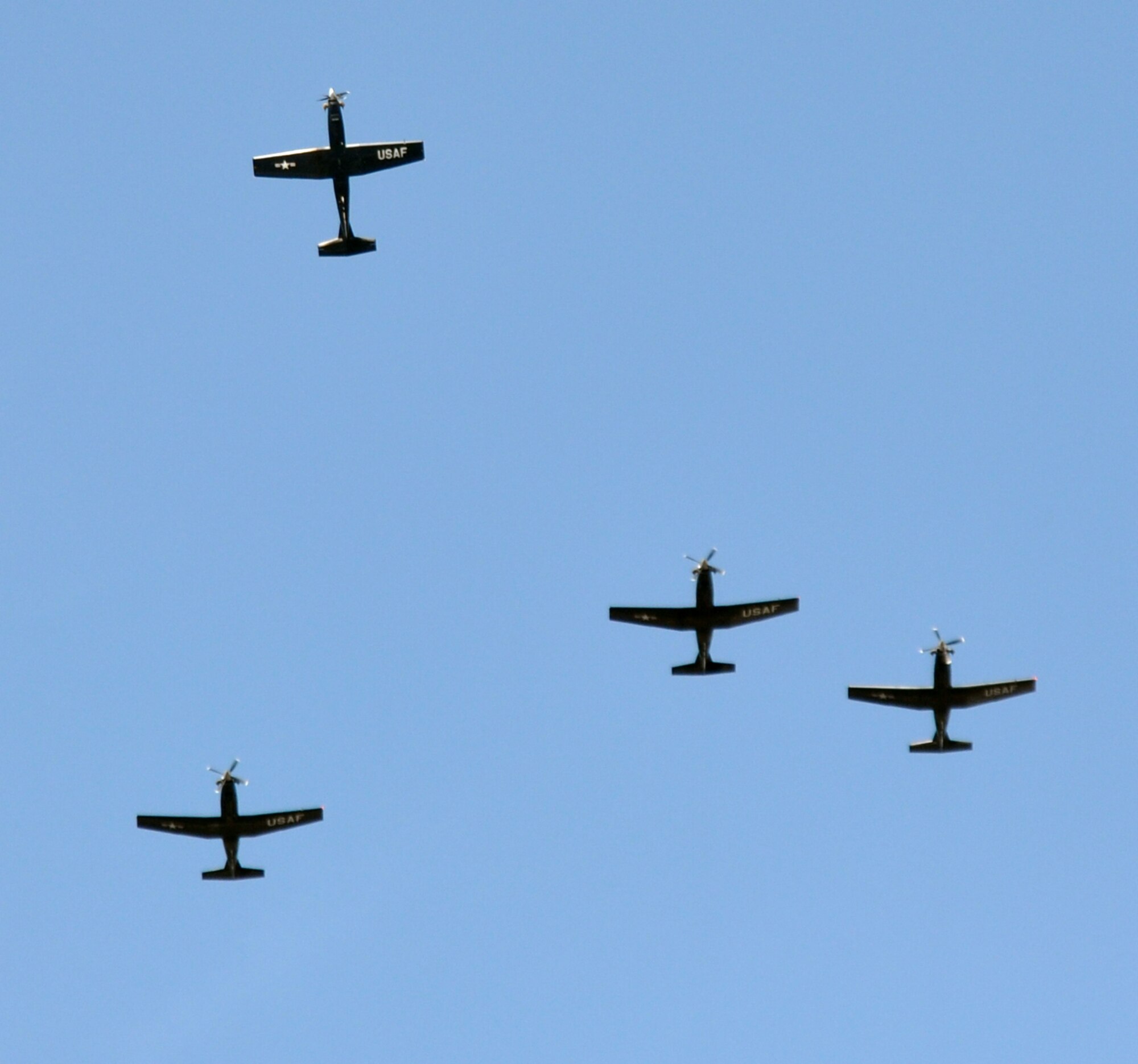 Four Air Force T-6 Texan II’s take part in a missing man aerial formation during the POW/MIA Remembrance Ceremony, Sept. 17 at Columbus Air Force Base, Miss. The missing man formation recognizes those servicemembers who are not with us, whether they are a POW, missing in action or have given their lives in defense of the nation. (U.S. Air Force photo/Staff Sgt. Jacob Corbin).