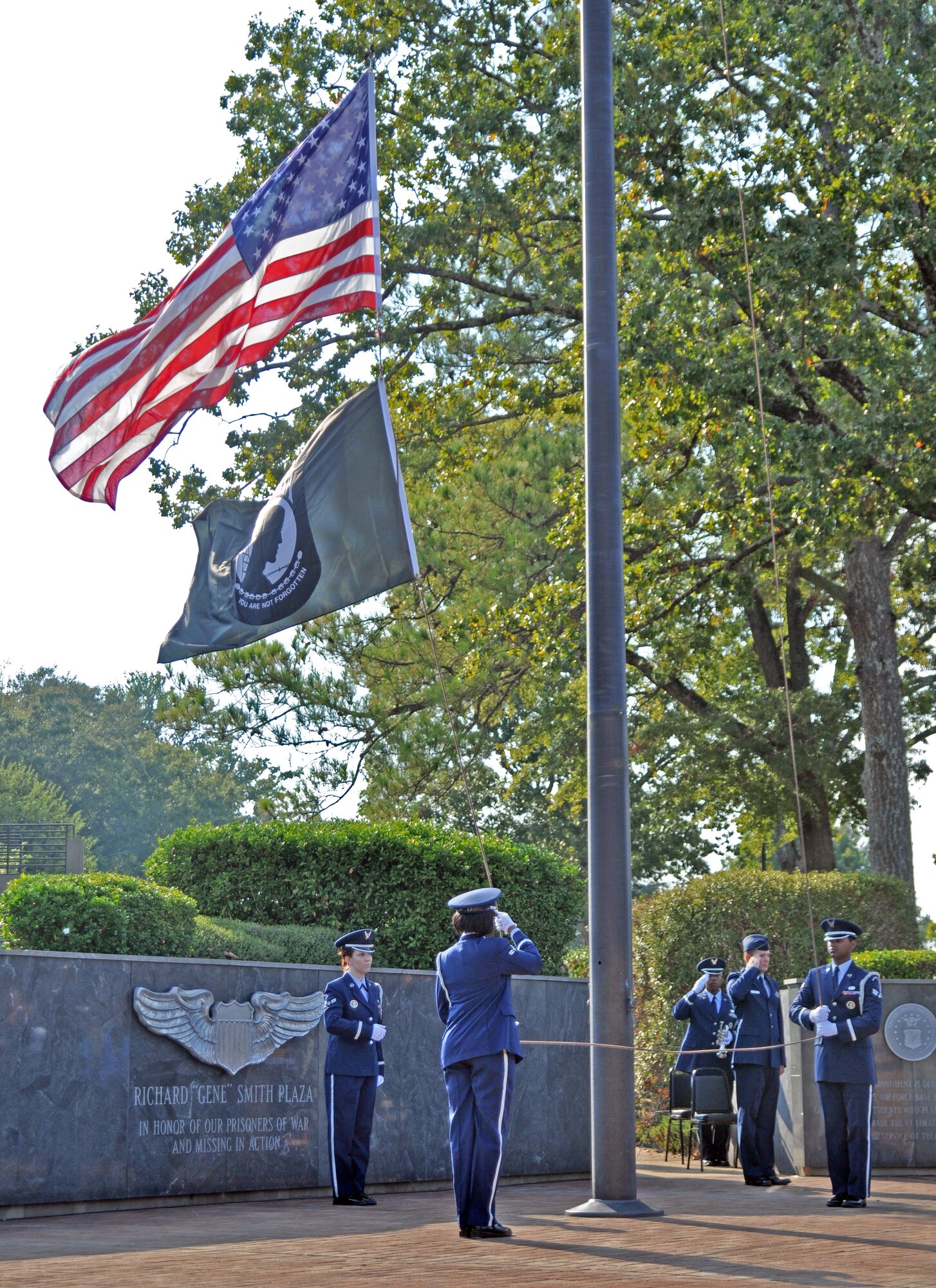 Members of the Columbus Air Force Base Honor Guard lower the U.S. and POW/MIA flags during retreat at this year’s POW/MIA Remembrance Ceremony, Sept. 17 at Columbus AFB’s Smith Plaza. In addition to retreat, the ceremony featured former Vietnam POW Retired Lt. Col. Richard “Gene” Smith as guest speaker, a missing man aerial formation and the laying of a wreath in remembrance of those that are lost, but not forgotten. (U.S. Air Force photo/Staff Sgt. Jacob Corbin).