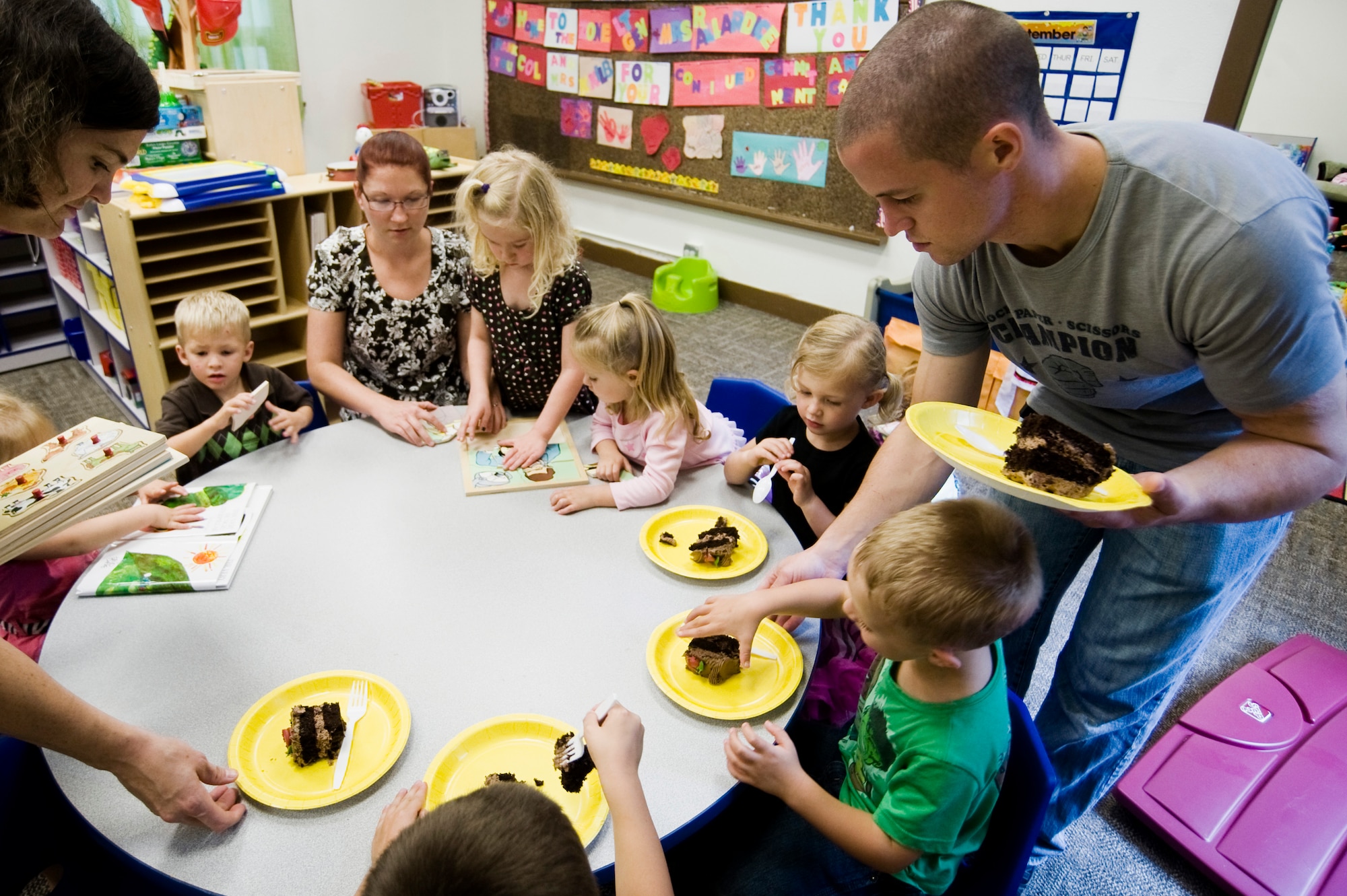 Families enjoy a snack after the re opening of the Escape Zone Sept. 17 at Joint Base Lewis-McChord, Wash. The facility offers families a chance to network with other people in similar situations and learn how to solve common problems. (U.S. Air Force Photo/Abner Guzman)