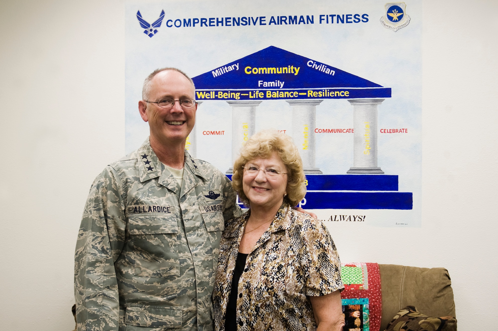 Lt. Gen. Robert R. Allardice, left, 18th Air Force Commander, and Mrs. Betty McBee, Escape Zone coordinator, pause for a photo in front of the mural at the re opening of the Escape Zone Sept. 17 at Joint Base Lewis-McChord, Wash. (U.S. Air Force Photo/Abner Guzman)