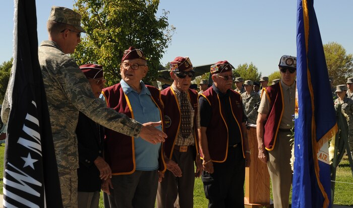 NELLIS AIR FORCE BASE, Nev.-- Brig. Gen. David Thompson, U.S Air Force Warfare Center vice commander, is joined by members of the the 7-11 Chapter of American Ex-Prisoners Of War during the POW / MIA recognition ceremony at Freedom Park Sept. 17. (U.S. Air Force photo by Senior Airman Stephanie Rubi) 
