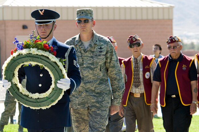 NELLIS AIR FORCE BASE, Nev.-- Staff Sgt. Stephen Perakes from the Nellis Honor Guard leads Brig. Gen. David Thompson, the U.S. Air Force Warfare Center vice commander, and members of the the 7-11 Chapter of American Ex-Prisoners Of War during a memorial wreath placement ceremony honoring Nevada veterans at the Prisoners of War/Missing in Action Recognition Day Ceremony at Freedom Park Sept. 17. (U.S. Air Force photo by Lawrence Crespo) 


 